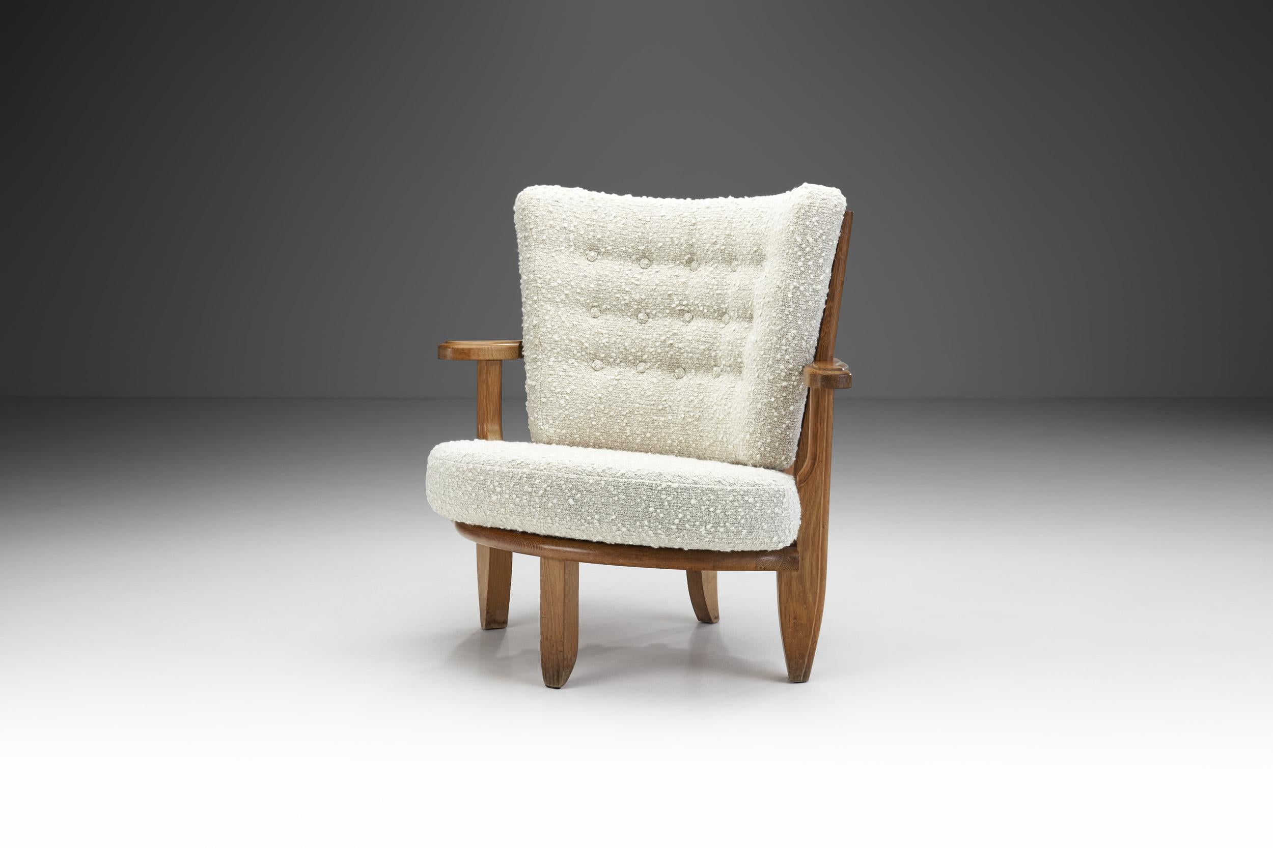 This rare oak chair is a delightfully unique piece even if measured against the other seating models in the repertoire of the French designer duo, Robert Guillerme and Jacques Chambron. This curving, spindle back model truly deserves the title of