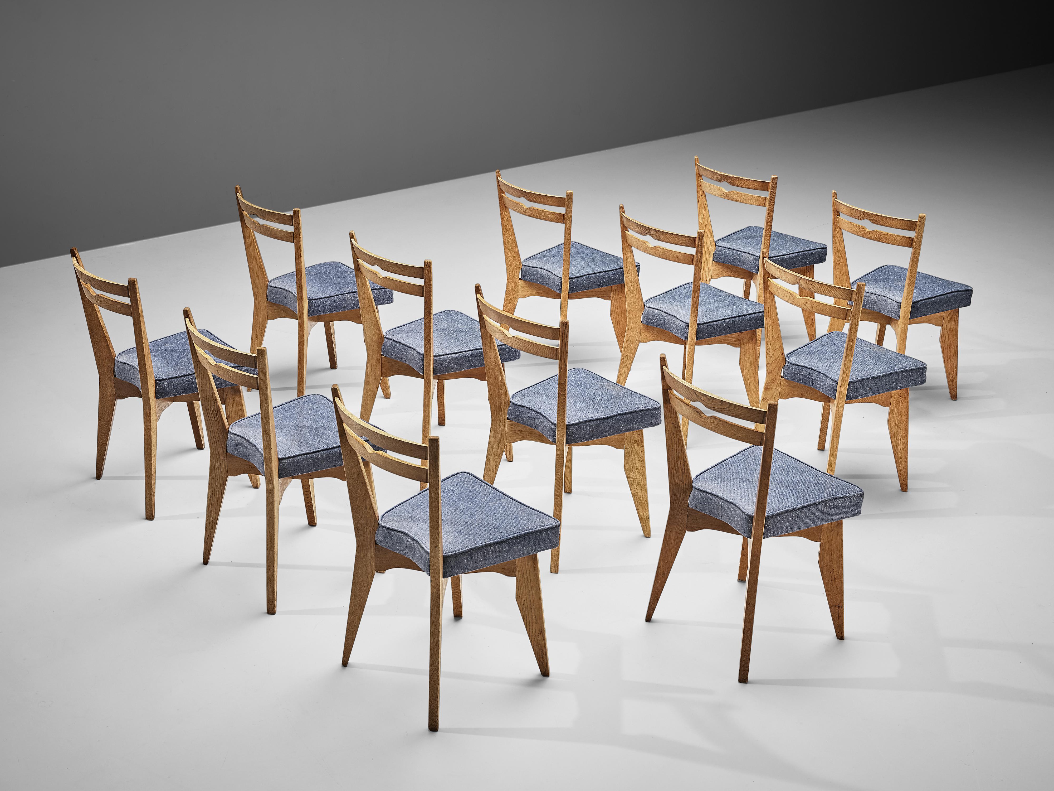 Guillerme et Chambron, set of twelve dining chairs, solid oak, fabric upholstery, France, 1960s

These dining chairs in solid oak are designed by the French designer duo Jacques Chambron and Robert Guillerme. On four tapered legs rests the seating