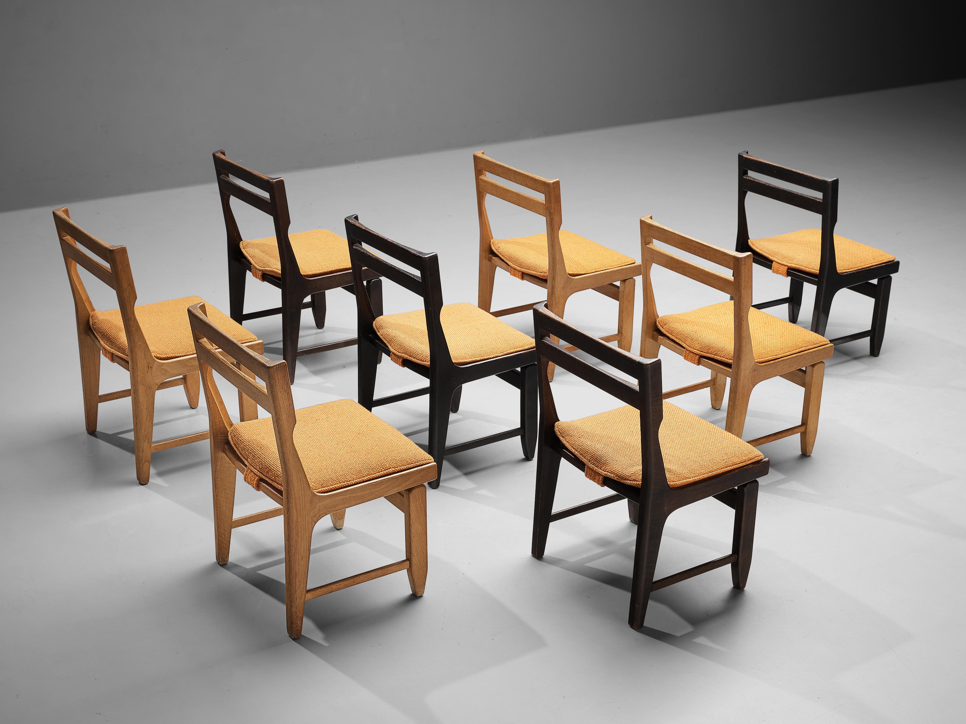 Guillerme et Chambron for Votre Maison, set of eight dining chairs, model 'Raphaël', dark stained oak, fabric upholstery, France, 1960s 

This set of eight dining chairs shows the typical traits of the designs by French designer duo Guillerme et
