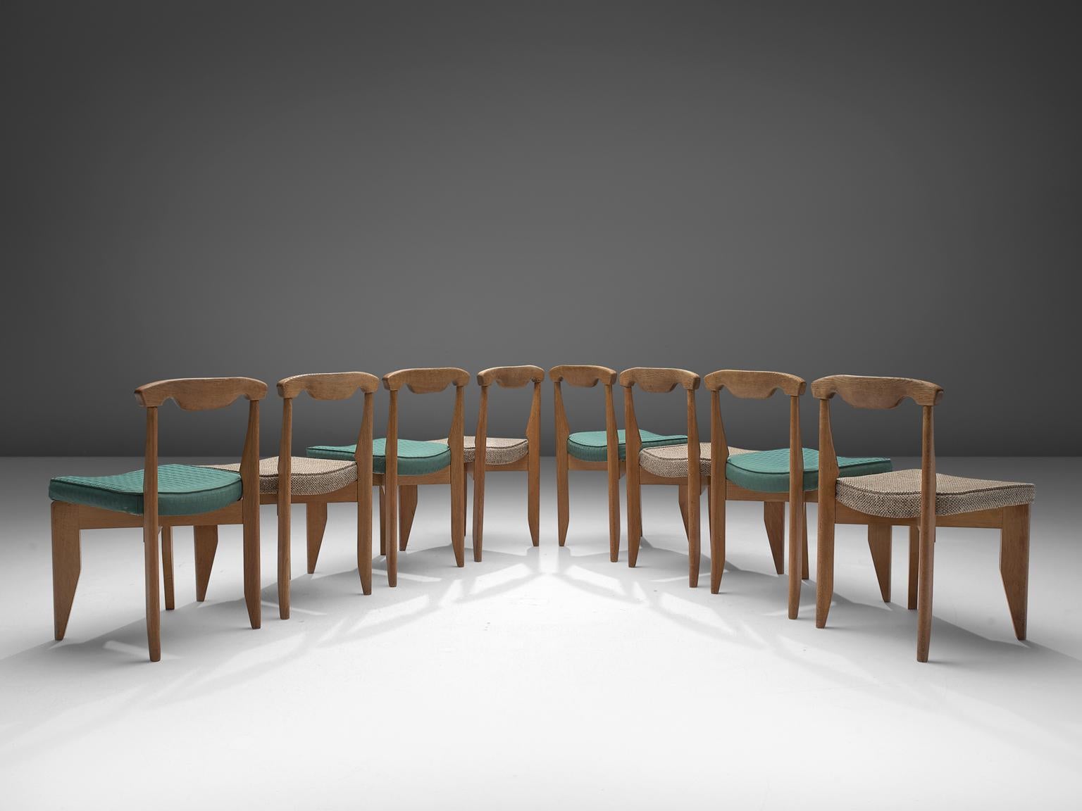 Guillerme et Chambron, set of 8 dining chairs, oak, beige and green fabric, France, 1960s

These distinctive chairs in beautifully patinated oak is by the French designer duo Jacques Chambron (1914-2001) and Robert Guillerme (1913-1990). The