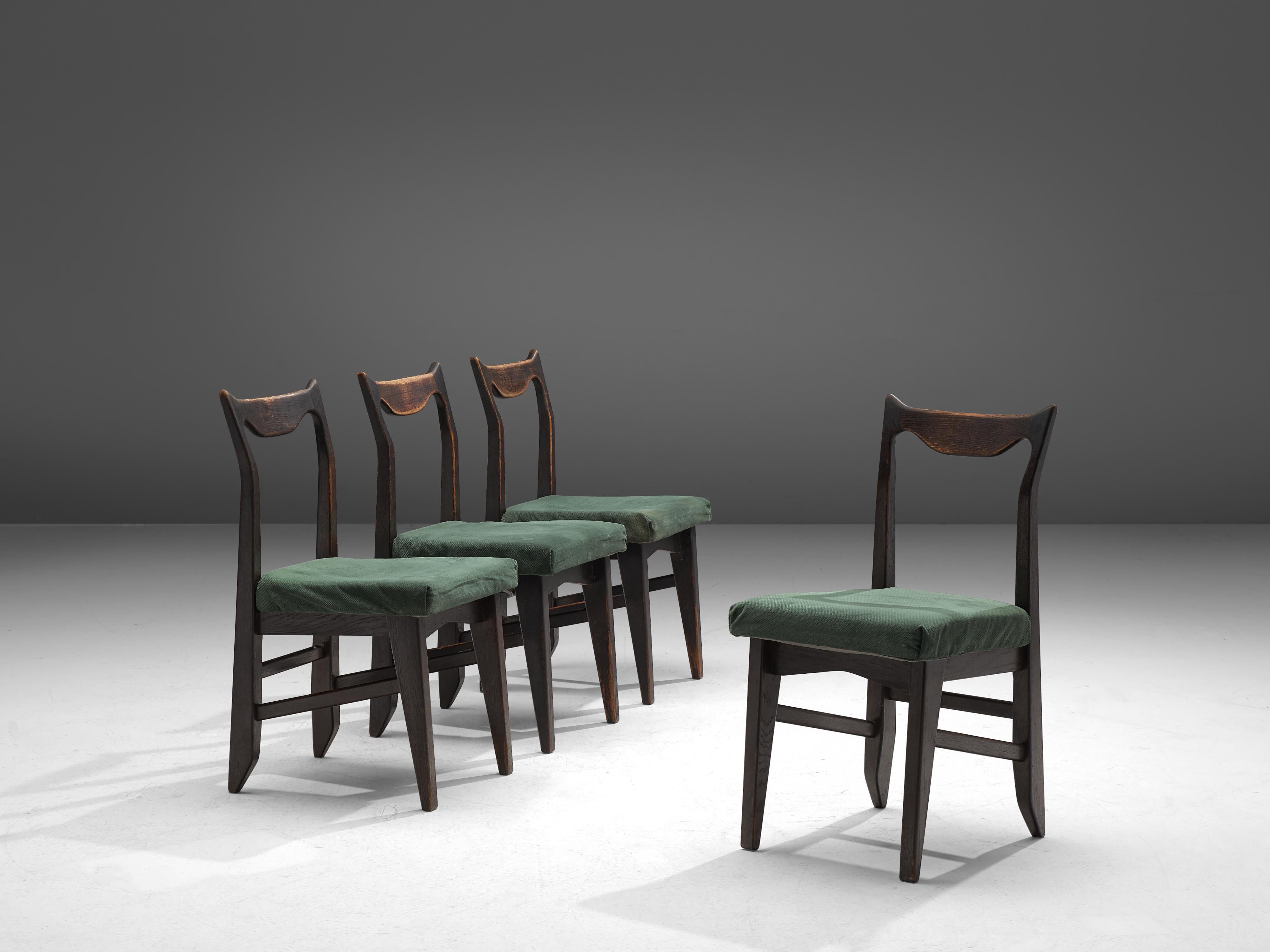 Guillerme et Chambron, set of 4 dining chairs 'Marie Claire', darkened oak and fabric, France, 1960.

Set of four darkened, solid oak dining chairs by Guillerme and Chambron. These chairs show the characteristic frame of this French designer duo.