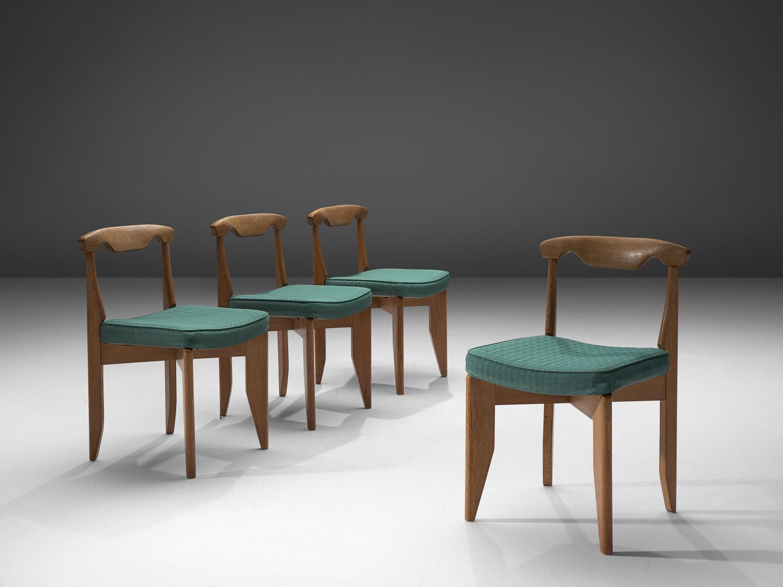 Guillerme et Chambron, set of four dining chairs, oak and green fabric, France, 1960s

These distinctive chairs in beautifully patinated oak is by the French designer duo Jacques Chambron (1914-2001) and Robert Guillerme (1913-1990). The dining