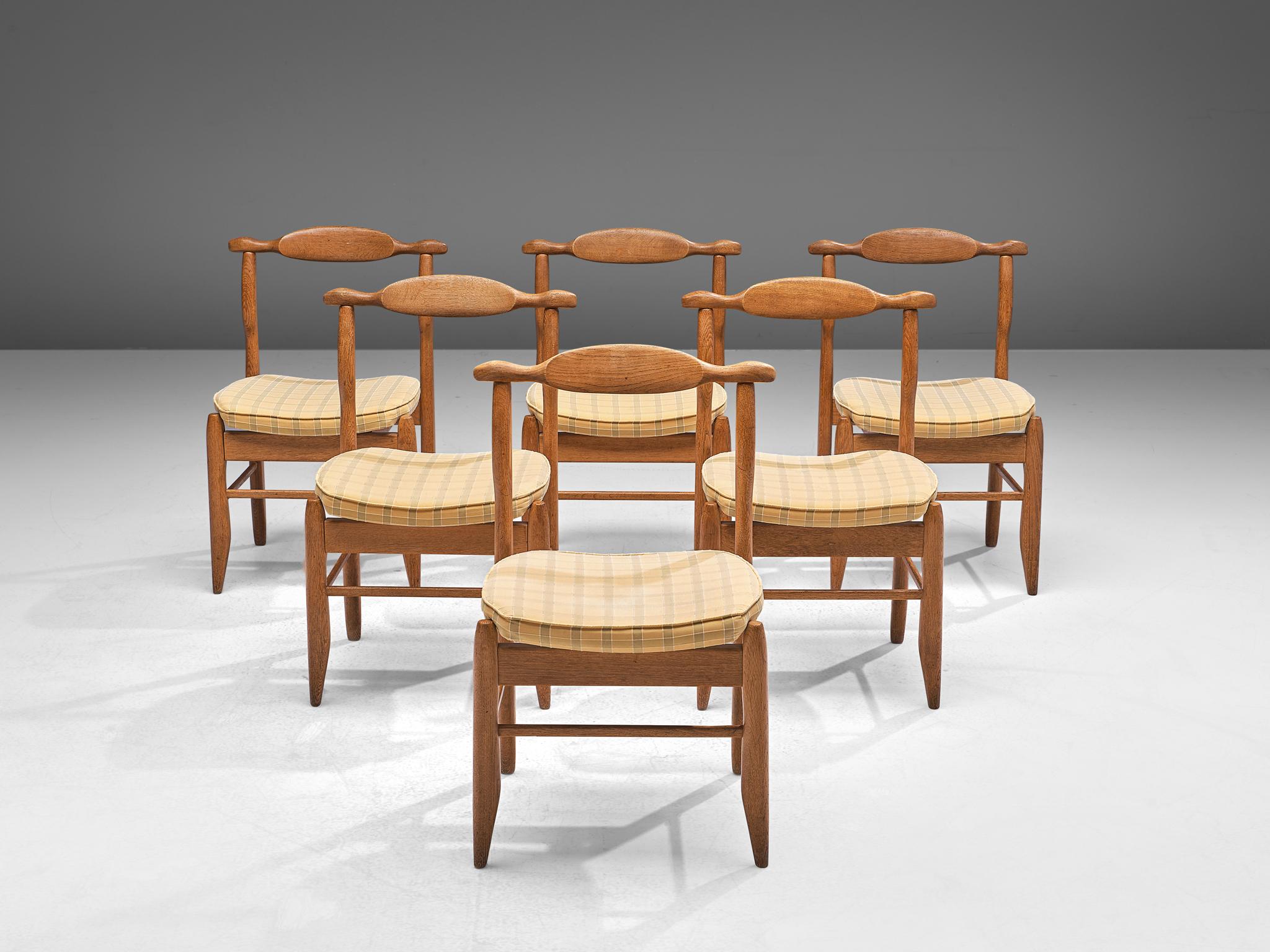 Guillerme & Chambron, set of six dining chairs, in oak and yellow checkered fabric, France, 1960s.

Set of six elegant carved dining chairs in solid oak by Guillerme and Chambron. These chairs show the characteristic frame of this French designer