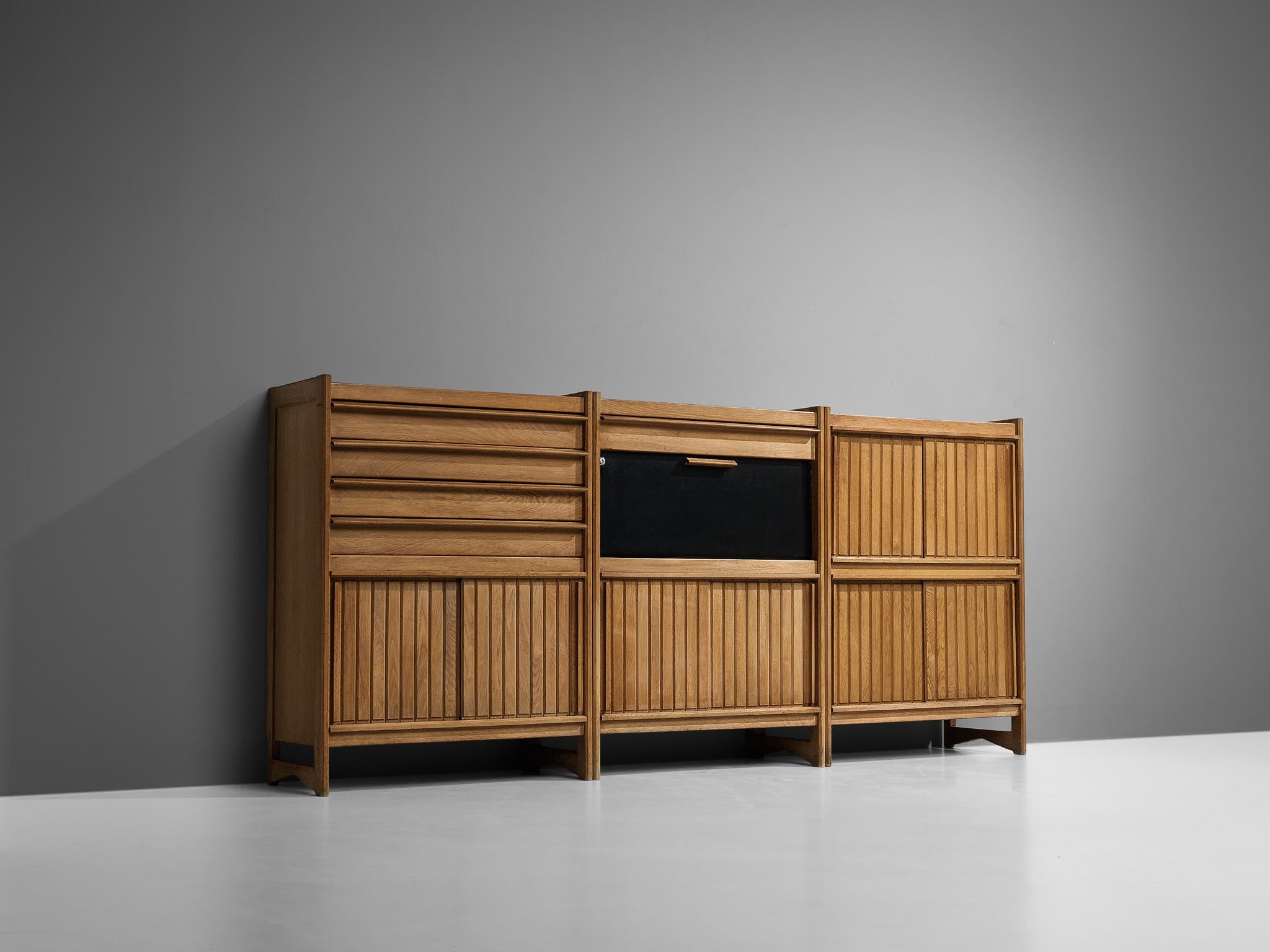 Guillerme et Chambron for Votre Maison, set of three cabinets, oak, leather France, 1960s

This outstanding set of three cabinets is based on a well-designed structure where aesthetics and functionally come hand in hand. The front holds the