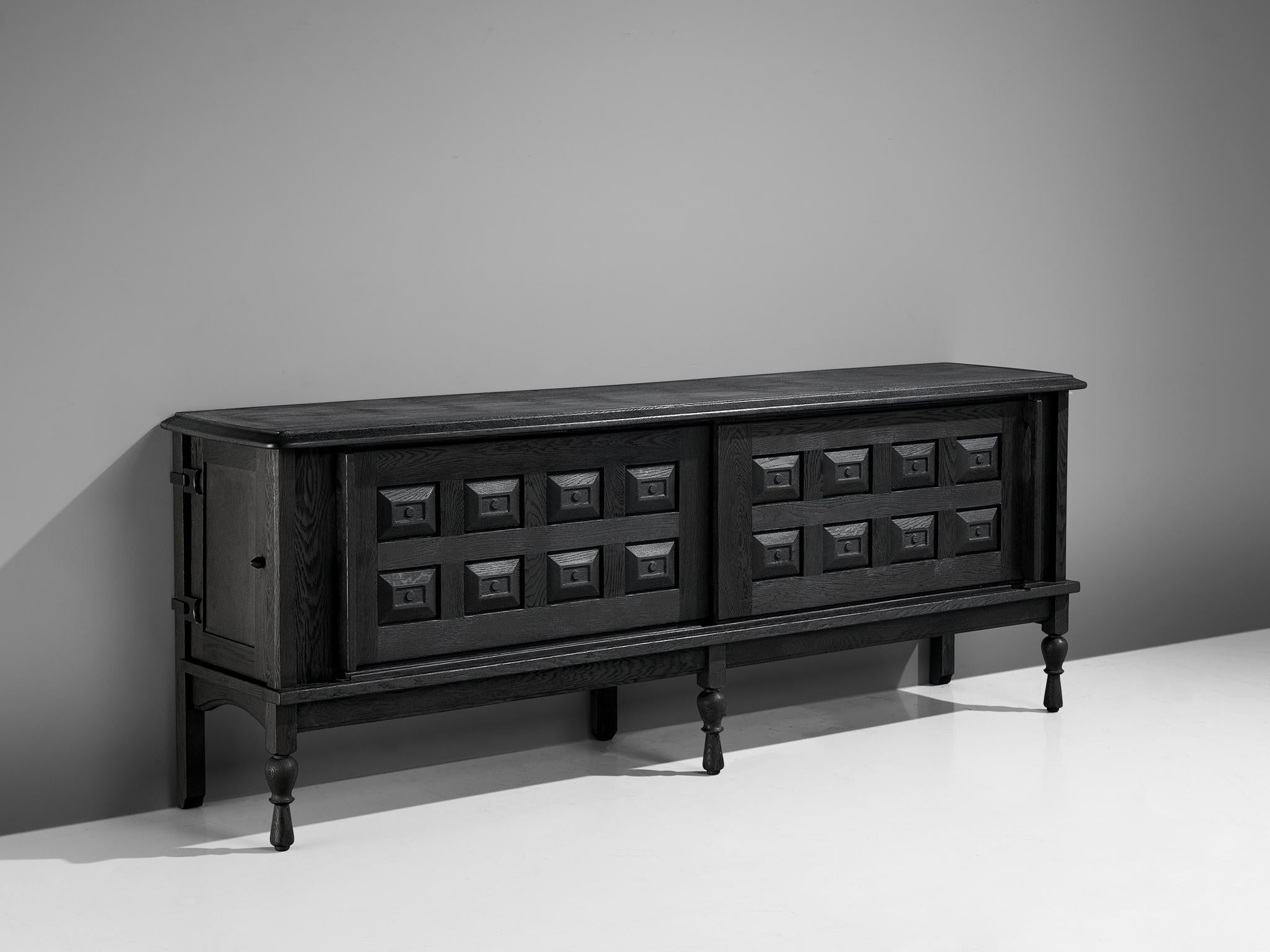 Guillerme et Chambron for Votre Maison, credenza, in black oak, France, 1960s.

Characteristic sideboard in ebonized solid oak. This cabinet holds all the characteristics of the French designer duo Jacques Chambron and Robert Guillerme. As many of