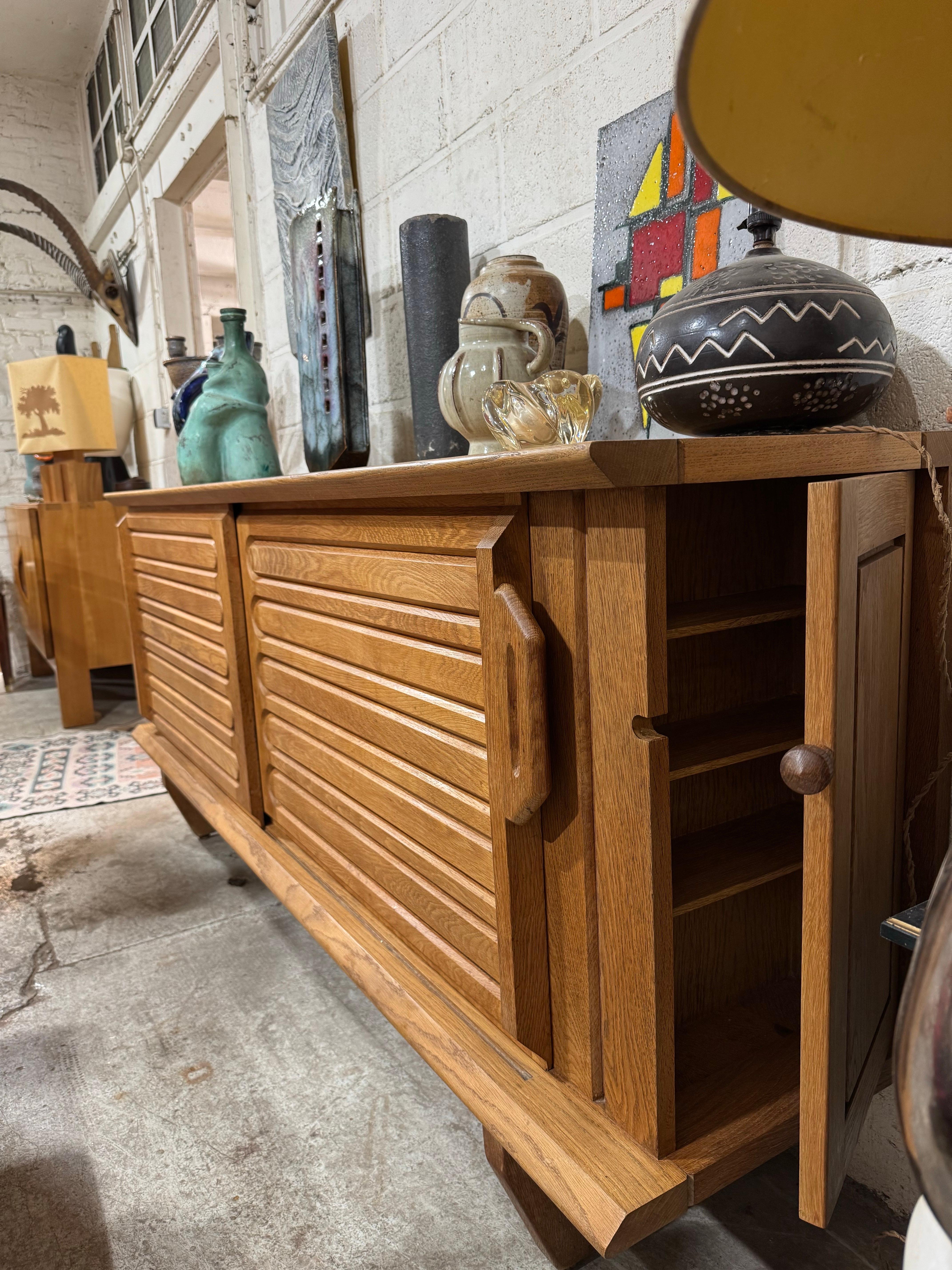 Robert GUILLERME et Jacques CHAMBRON (193 /2001( ÉDITION VOTRE MAISON 
Oak sideboard opening with 2 slides on the right side with ceramic on the left side by Boleslaw Danikowski
