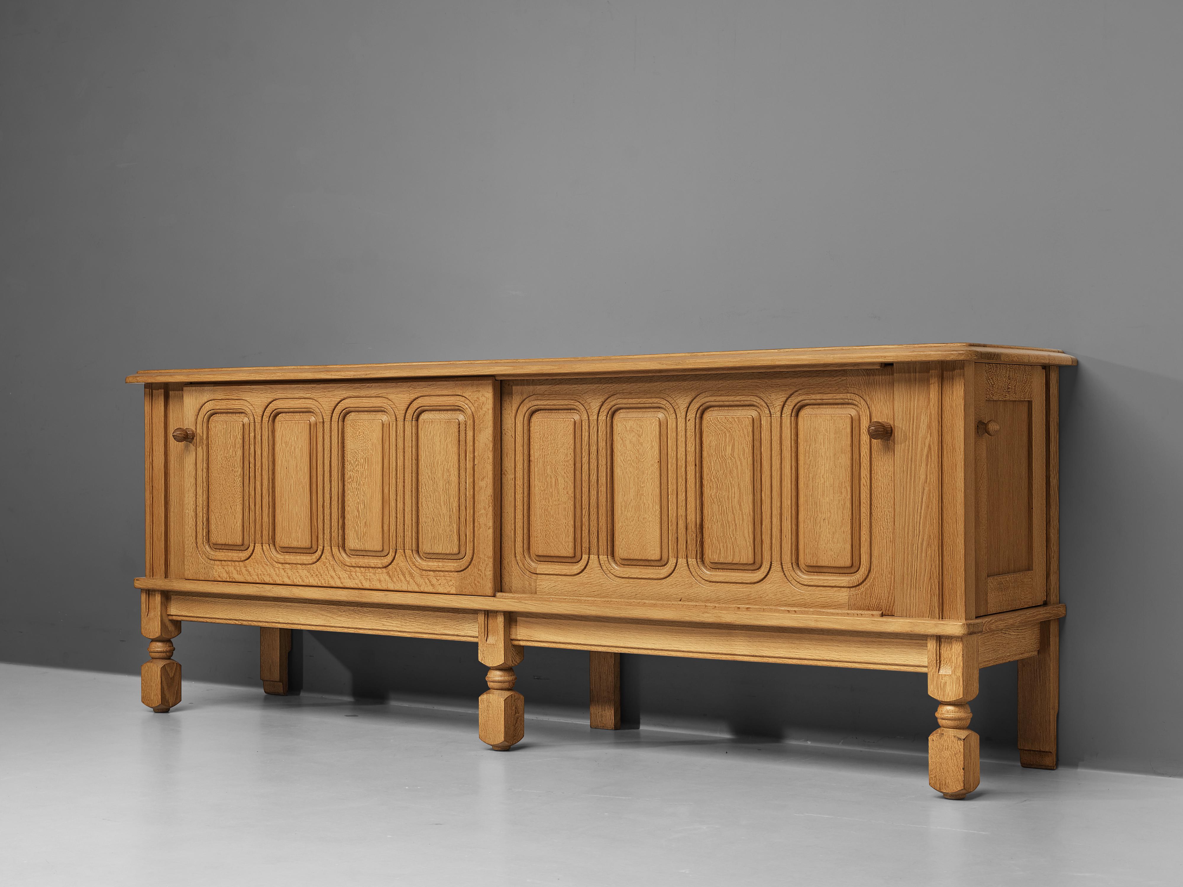 Guillerme et Chambron, sideboard, oak, France, 1960s.

This charming sideboard is made by the designer duo Guillerme & Chambron. This particular design is characterized by a solid construction that is noticeable in the engraved lines on the