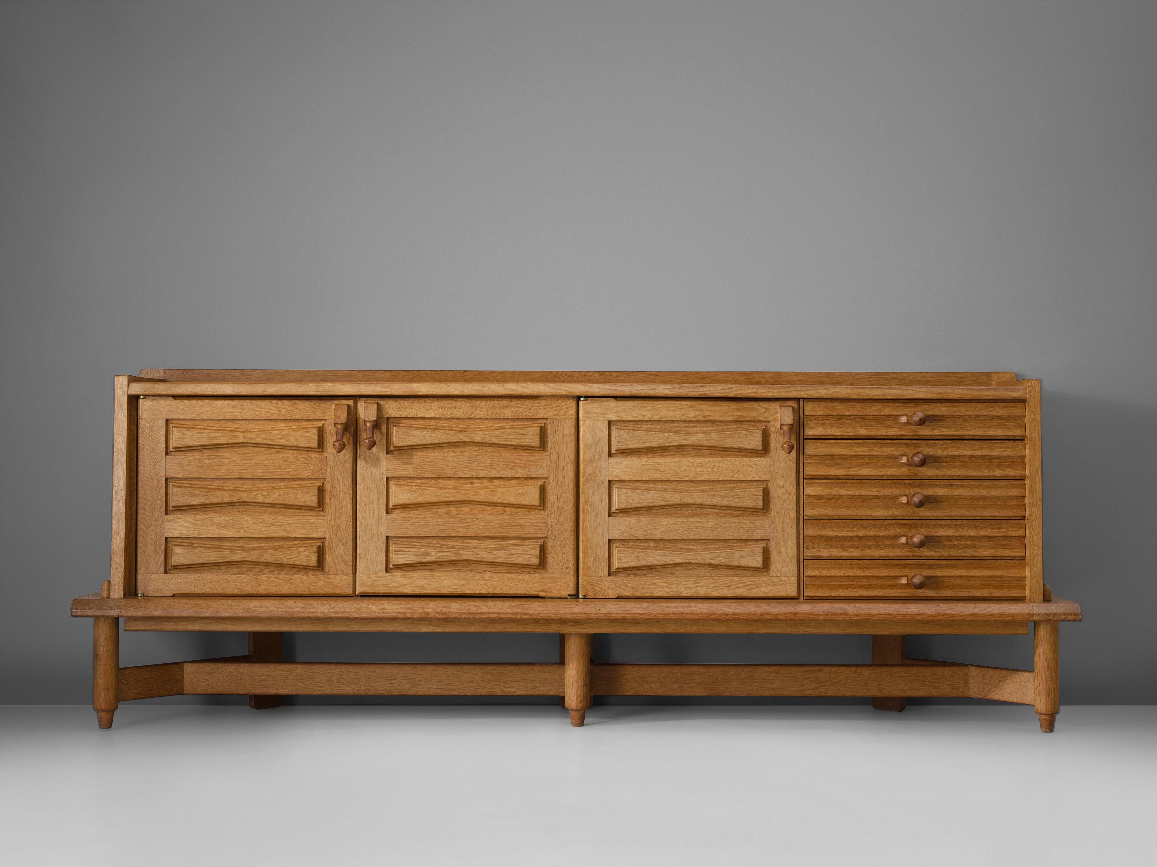 Guillerme et Chambron for Votre Maison, credenza 'Saint-Veran', oak, ceramic, France, 1960s.

Characteristic sideboard in solid oak. This cabinet holds the characteristics of the French designer duo Jacques Chambron and Robert Guillerme. As many