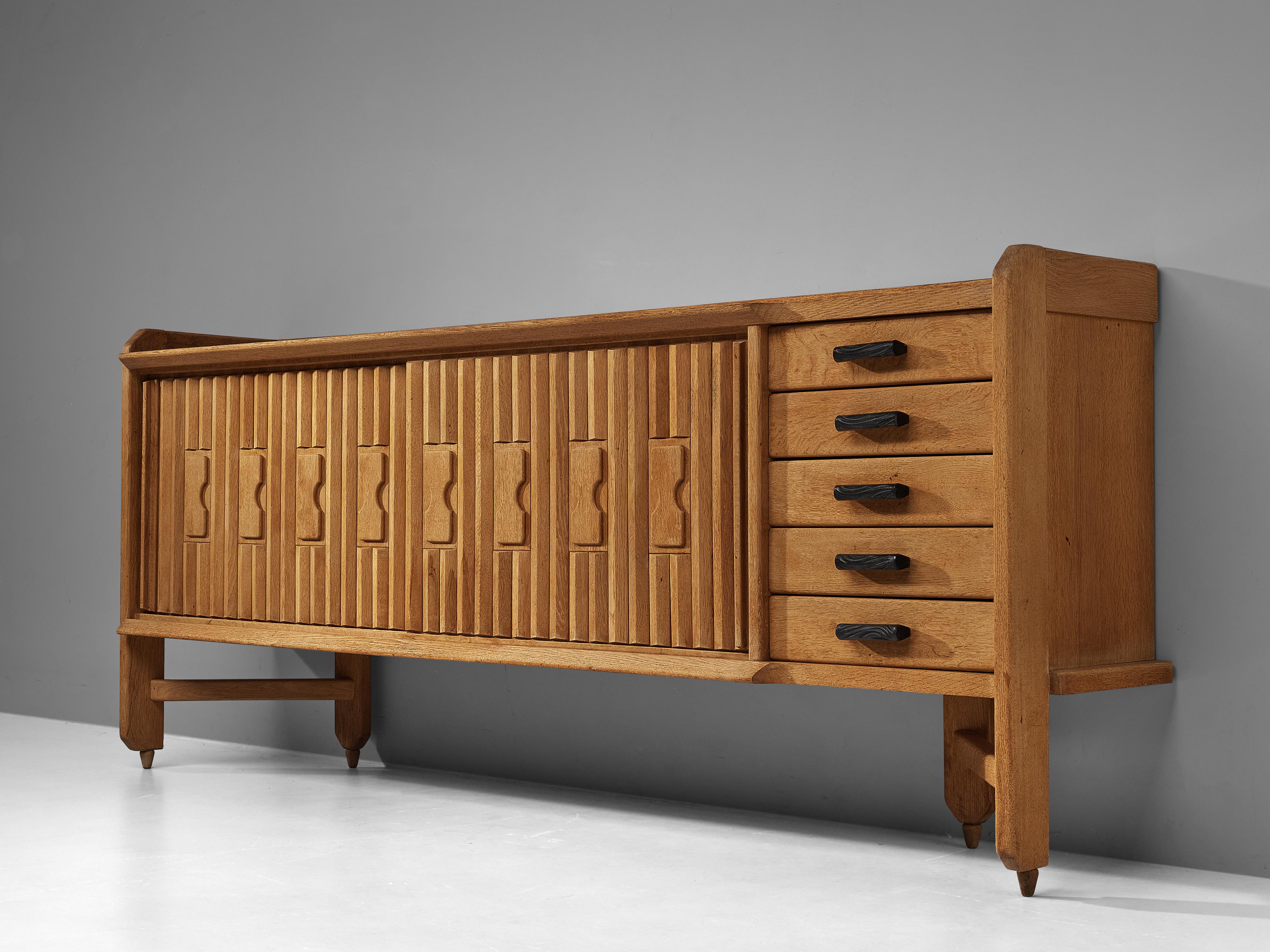 Guillerme et Chambron, sideboard, oak, ceramic, France, 1960s 

Characteristic sideboard in solid oak with ceramic tiles. This cabinet holds the characteristics of the French designer duo Guillerme et Chambron. The base has typical legs and