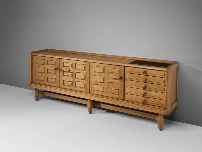Guillerme et Chambron, sideboard, oak, ceramic, France, 1960s 

Characteristic sideboard in solid oak with ceramic tiles. This credenza holds the characteristics of the French designer duo Guillerme et Chambron. The base has characteristic legs that