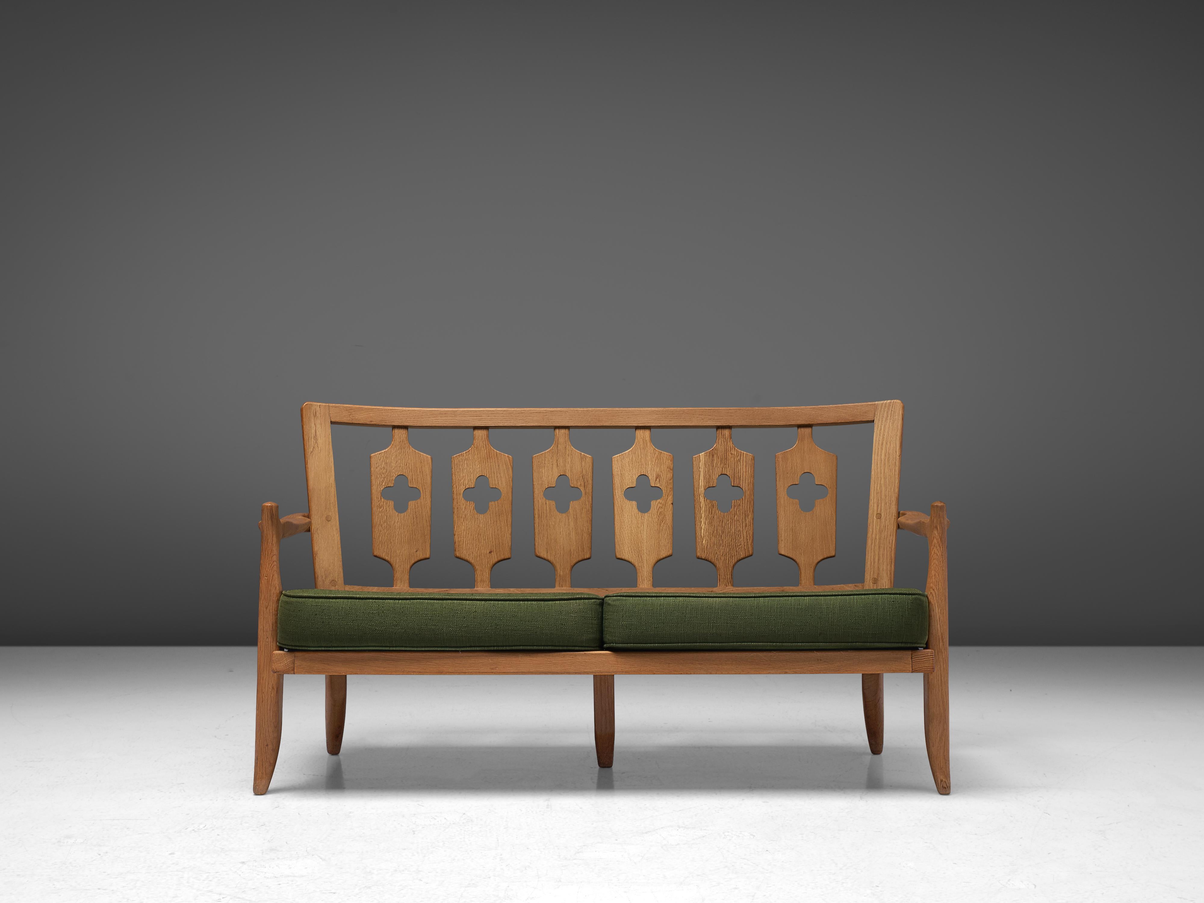 Guillerme et Chambron, sofa, oak, green fabric, France, 1960s

Beautiful two-seat sofa by Guillerme and Chambron, in solid oak with the typical characteristic decorative details at the back and sculpted forms of the legs. The thick, green cushions