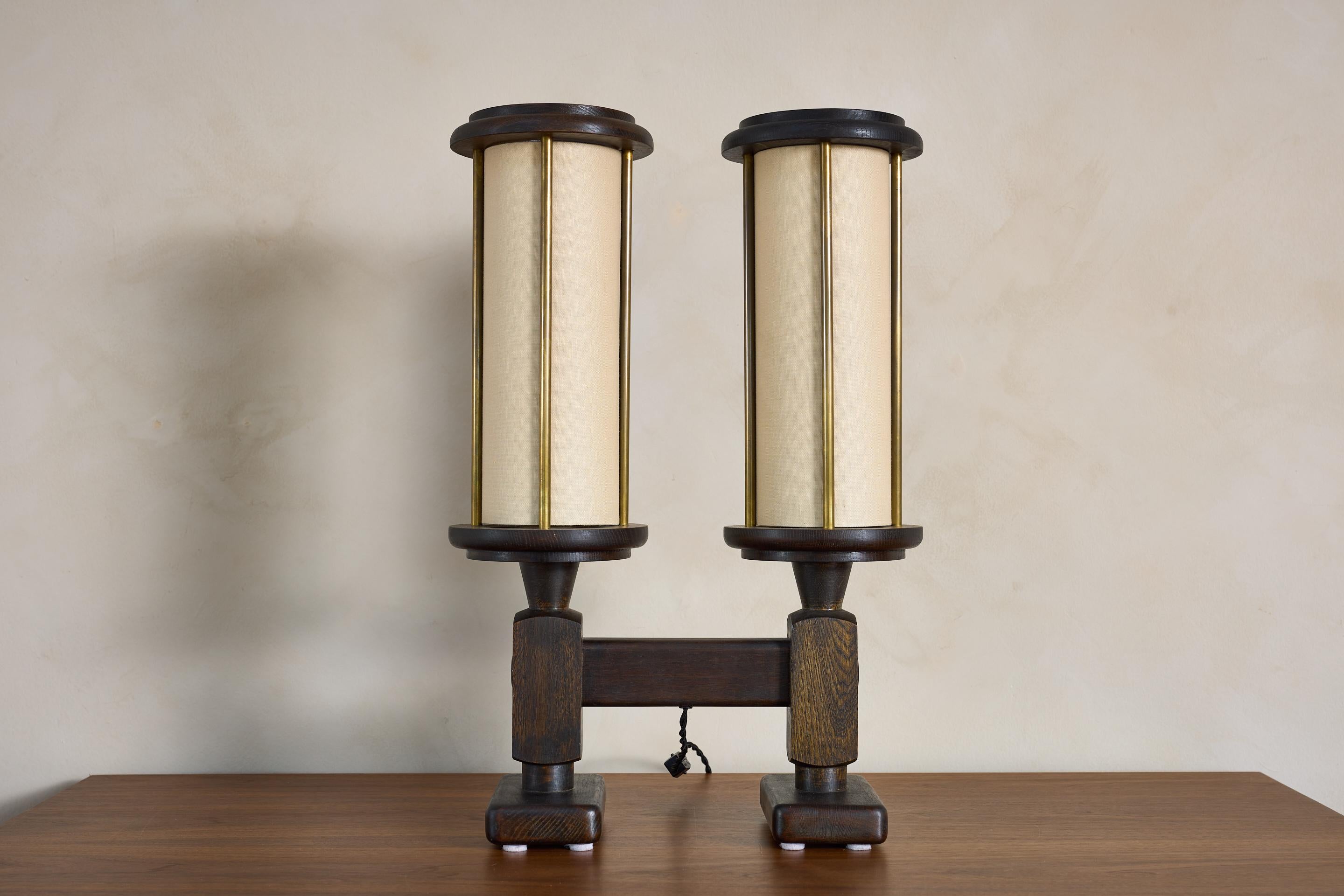 Rare dual head Guillerme et Chambron table lamp, France 1950's

Dark oak frame with tall cylindrical linen shades with brass rod detail

Newly rewired.

Fantastic piece!