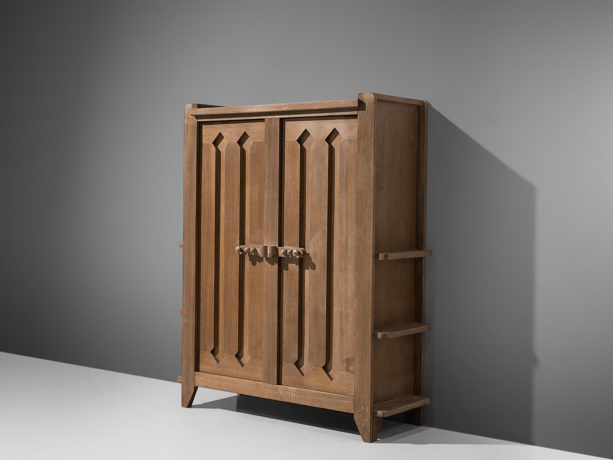 Guillerme et Chambron, armoire, oak, France, 1960s.

This case piece is designed by Guillerme and Chambron and features geometric engravings in the doors that offers plenty of storage. The armoire contains characteristic, sturdy handles of
