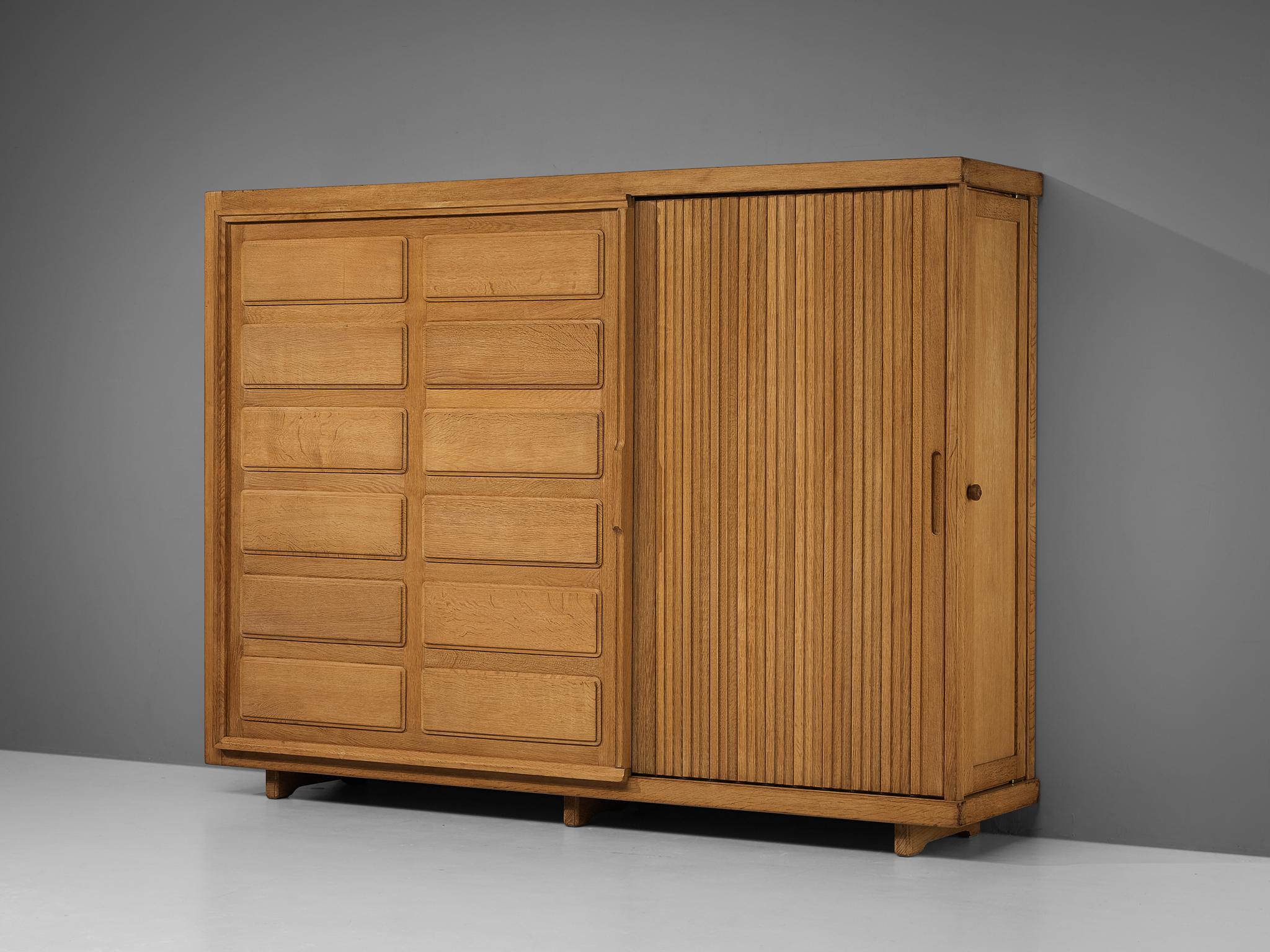 Guillerme et Chambron for Votre maison, armoire, oak, France, 1960s

This grandiose wardrobe is a good example of excellent woodworking by virtue of the graphical designed door panels illustrating elongated, vertical lines and geometrical wooden