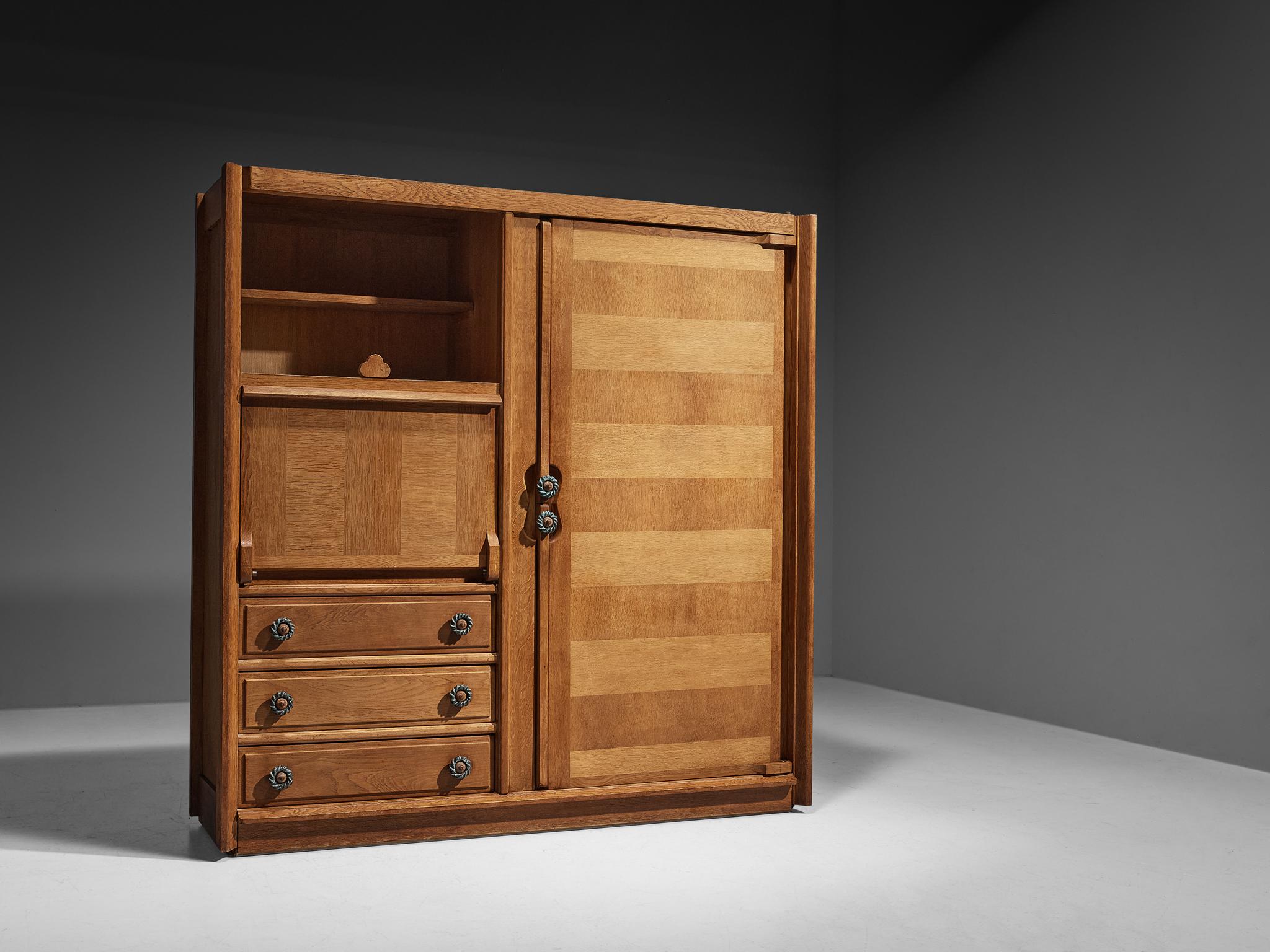 Guillerme et Chambron, armoire, oak, leather, ceramic, France, 1960s

This wardrobe is based on a well-designed structure where aesthetics and functionally come hand in hand. The door panels holds the characteristics of the French designer duo