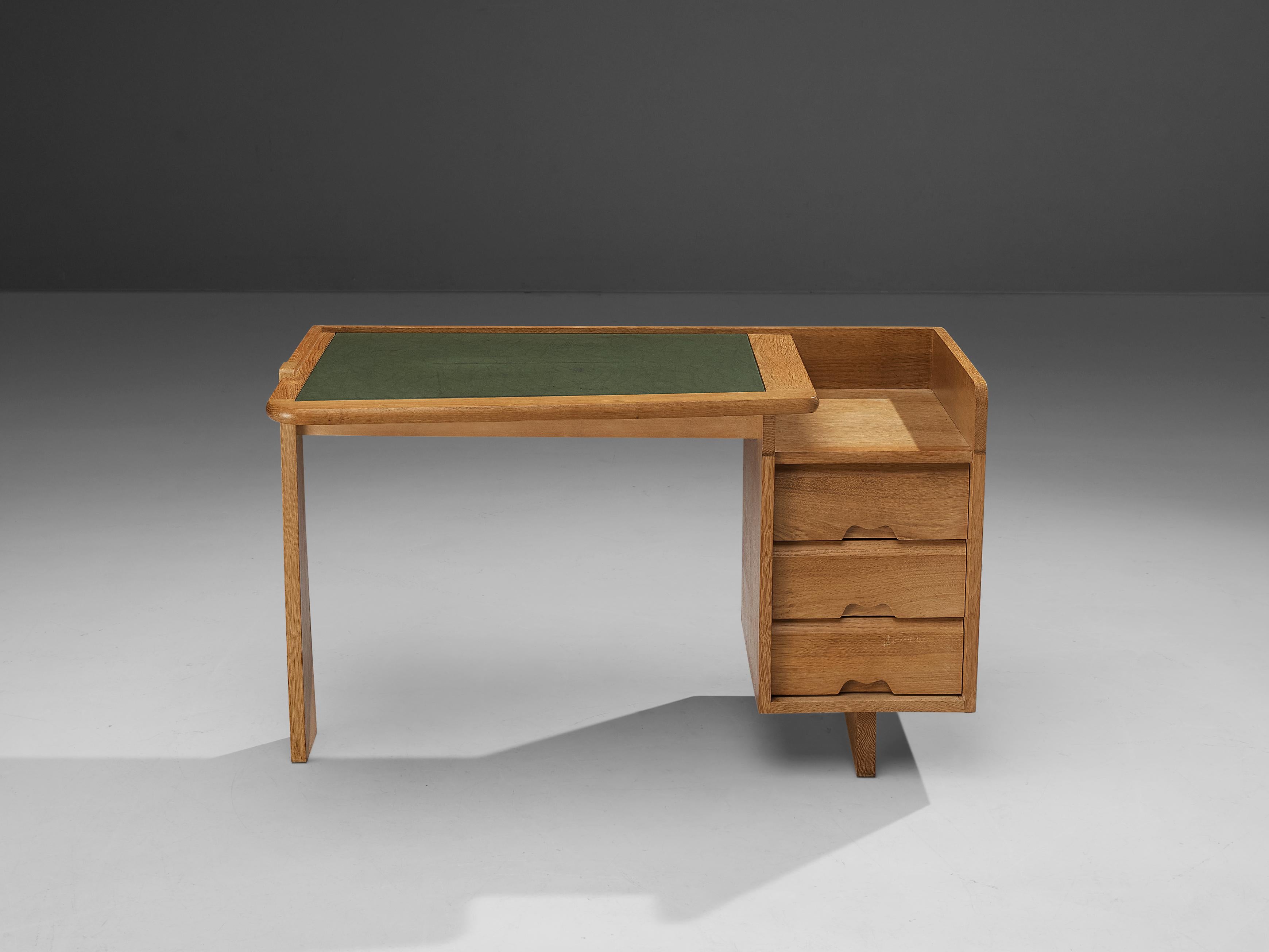 Guillerme et Chambron for Votre Maison, writing desk, oak, leather, France, 1960s. 

This desk is designed by the renowned French duo Guillerme et Chambron. This item holds an utterly well-balanced construction supported by the characteristic