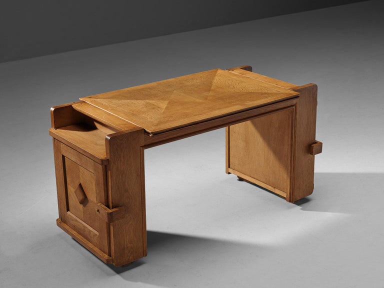 Guillerme et Chambron for Votre Maison, writing desk, oak, France, 1960s.

This desk is designed by the renowned French duo Guillerme et Chambron. This item holds an utterly well-balanced construction supported by the characteristic aesthetic