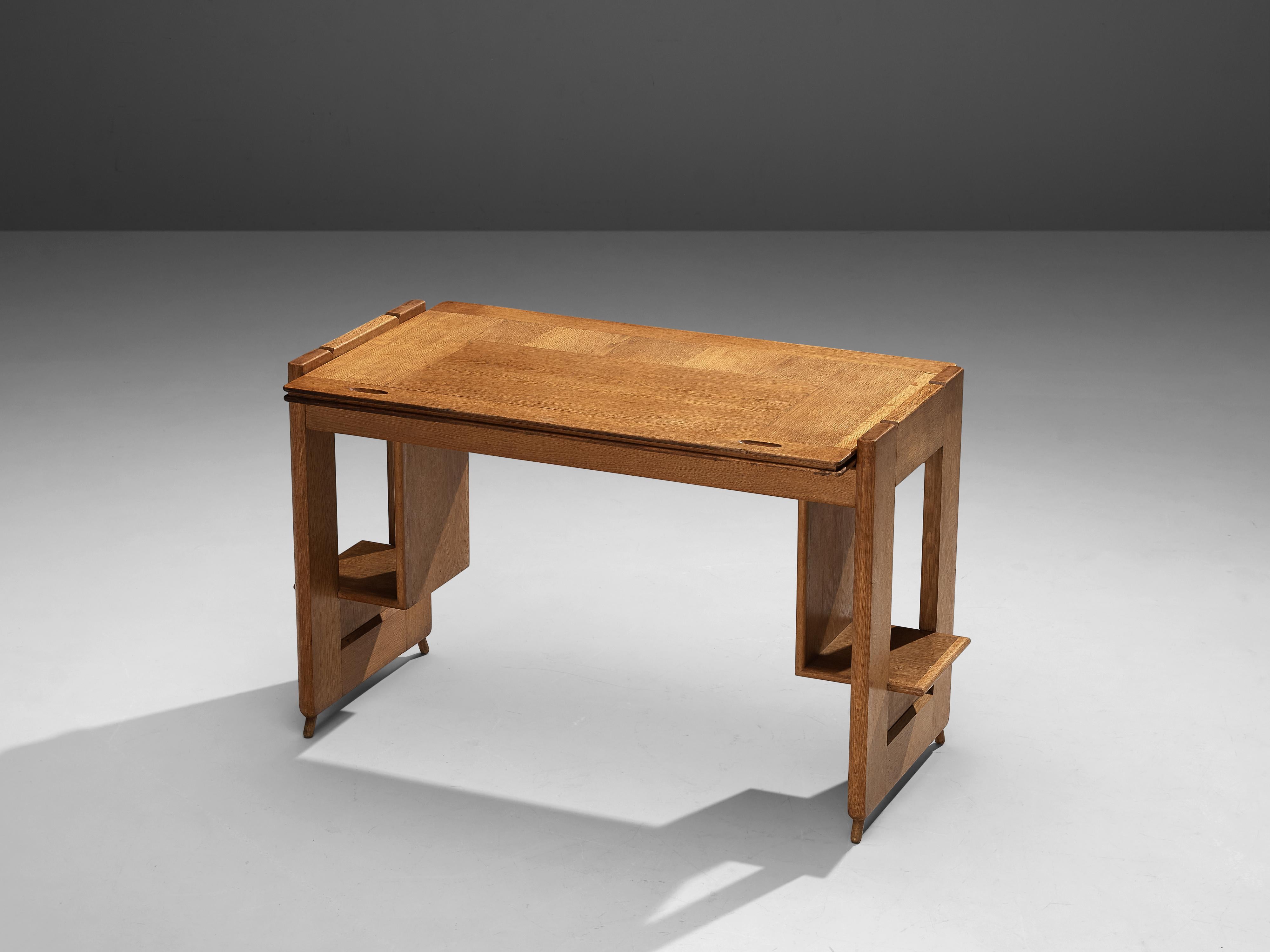 Guillerme et Chambron, desk, oak, France, 1950s

Delicate writing desk by the French designer duo Guillerme et Chambron. The desk in solid oak features two flat legs with integrated storage trays. Special feature holds the tabletop which easily