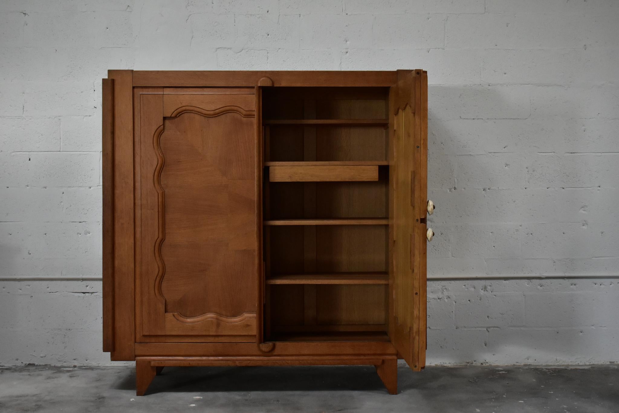 Guillerme et Chambrone for Votre Maison, France 1960’s 

This highboard was designed by Robert Guillerme and Jacquese Chambron. Renowned for their craftsmanship and functionality, this wardrobe features two symmetrical carved oak doors followed by
