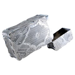 Guilloche silver cardboard box with engraved city motifs and wavy border