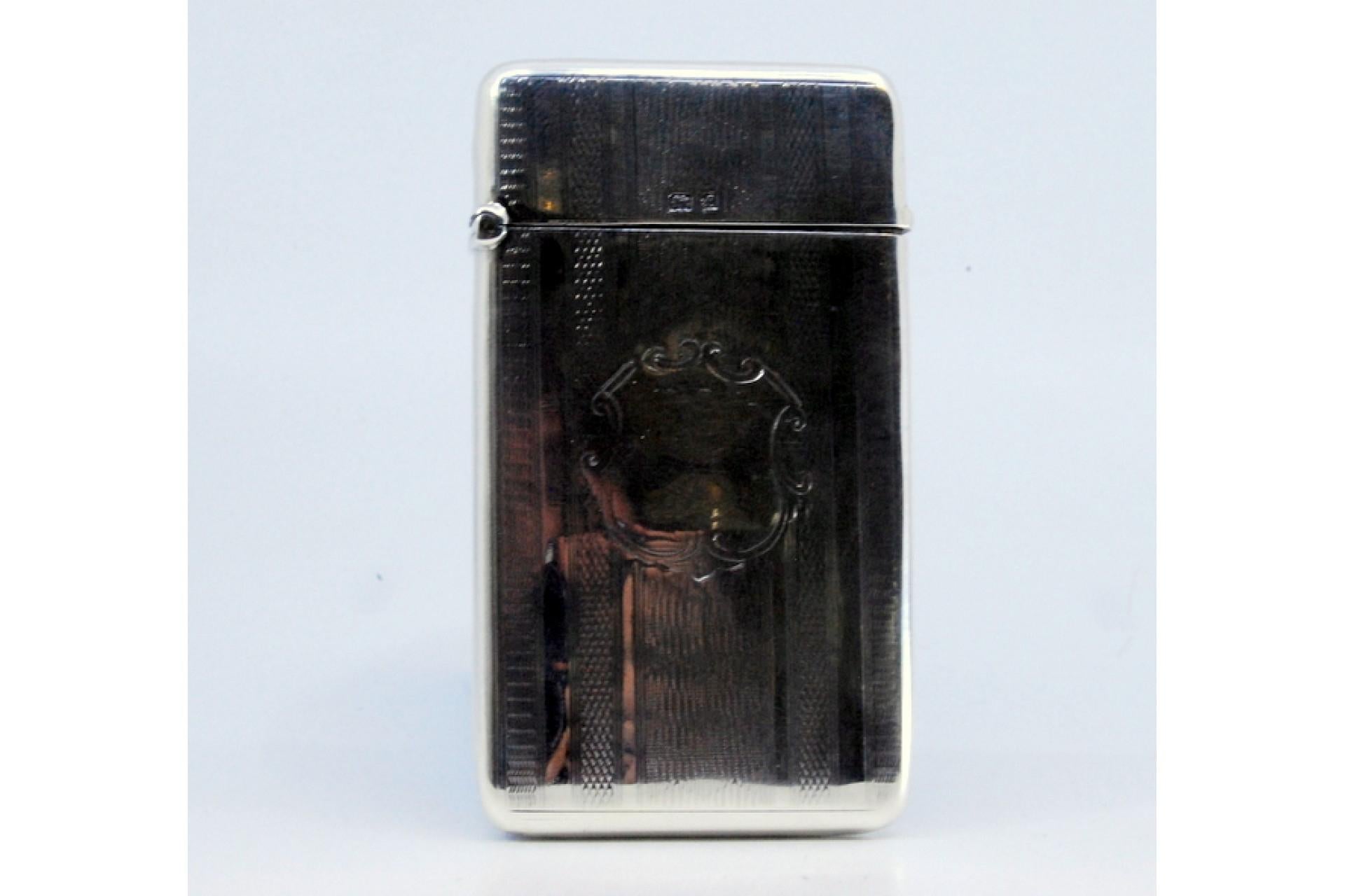 Description: Guilloche silver card case with hinged lid enclosing a monogram card. Metal: Silver. Origin: English. Brand: Birmingham. Weight: 47.92 grams. Dimensions: 8.3x4.8cm. Content: 925/1000. Assay Mark: Yes, 1905 by Joseph Gloster. Additional