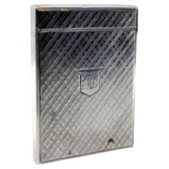 Guilloche silver cartoner with central monogram card and hinged lid