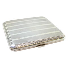 Guilloche silver case with beveled corners, top bands, gold interior, hinged lid