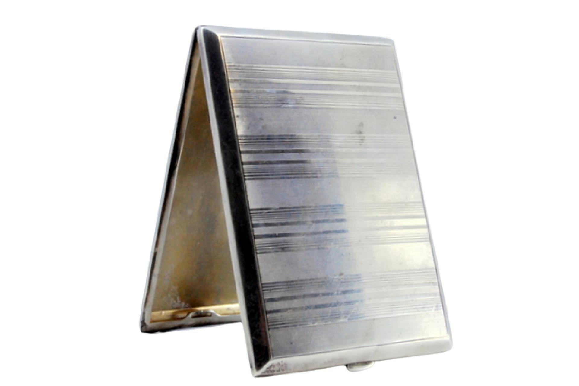 Description: Guilloche silver cigarette case with bands at the top, friezes on the surroundings and hinged lid. Metal: Silver. Origin: German. Brand: Unknown. Weight: 137.43 grams. Dimensions: 11.7x8.2cm. Content: 900/1000. Assay Mark: Yes.