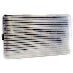 Guilloche silver cigarette case with bands along the length and hinged lid