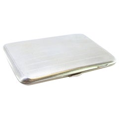 Guilloche silver cigarette case with bands at the top and hinged lid