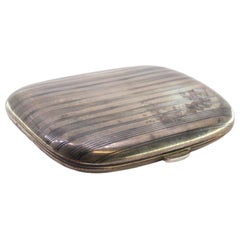 Guilloche silver cigarette case with curved bands and a gold interior