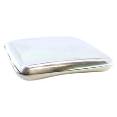 Guilloche silver cigarette case with curved bands at the top and gold interior