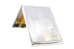 Guilloche silver cigarette case with lengthwise bands around monogram plate