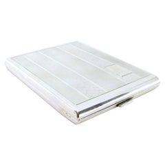 Guilloche silver cigarette case with lengthwise bands around monogram plate