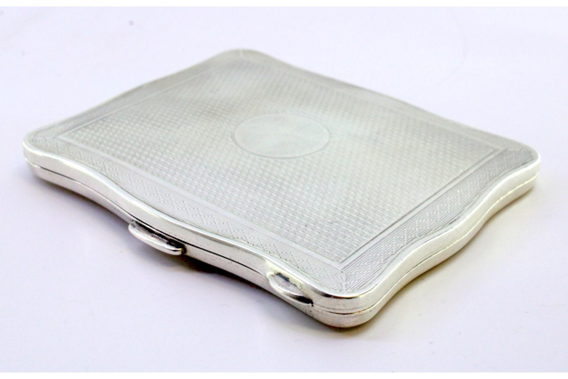 Description: Guilloche silver cigarette case with wavy edges and gold interior with hinged lid and spring clasp. Metal: Silver. Origin: English. Brand: Birmingham. Weight: 64.91 grams. Dimensions: 8.2cm x 6.9cm. Content: 925/1000. Assay Mark: Yes,