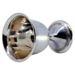 Guilloche silver egg cup set on a round base with friezes