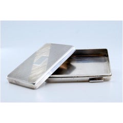 Guilloche silver pill box with a monogrammed card on the removable lid