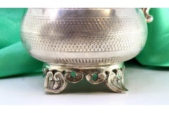 Guilloche silver wine jug with four scalloped feet