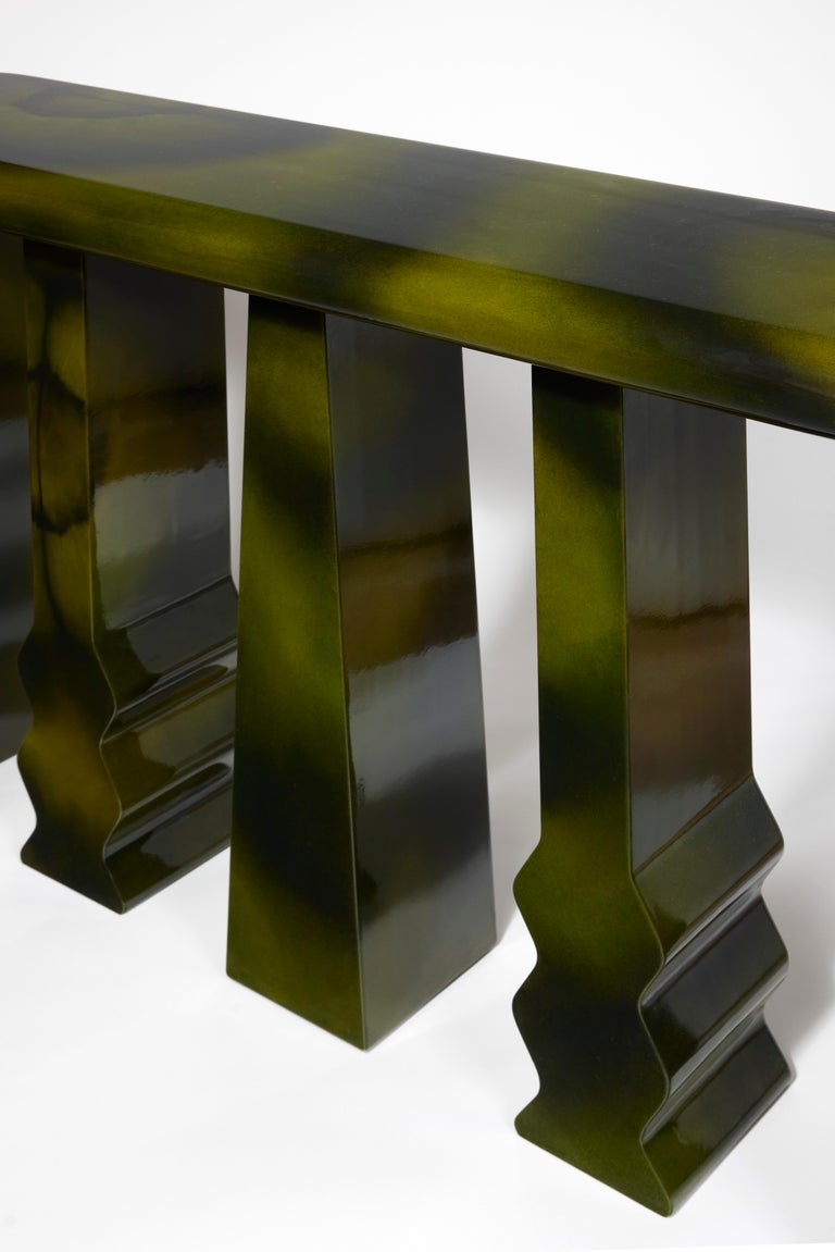 Console table lacquered highly gloss with a black and green deep cloudy effect.