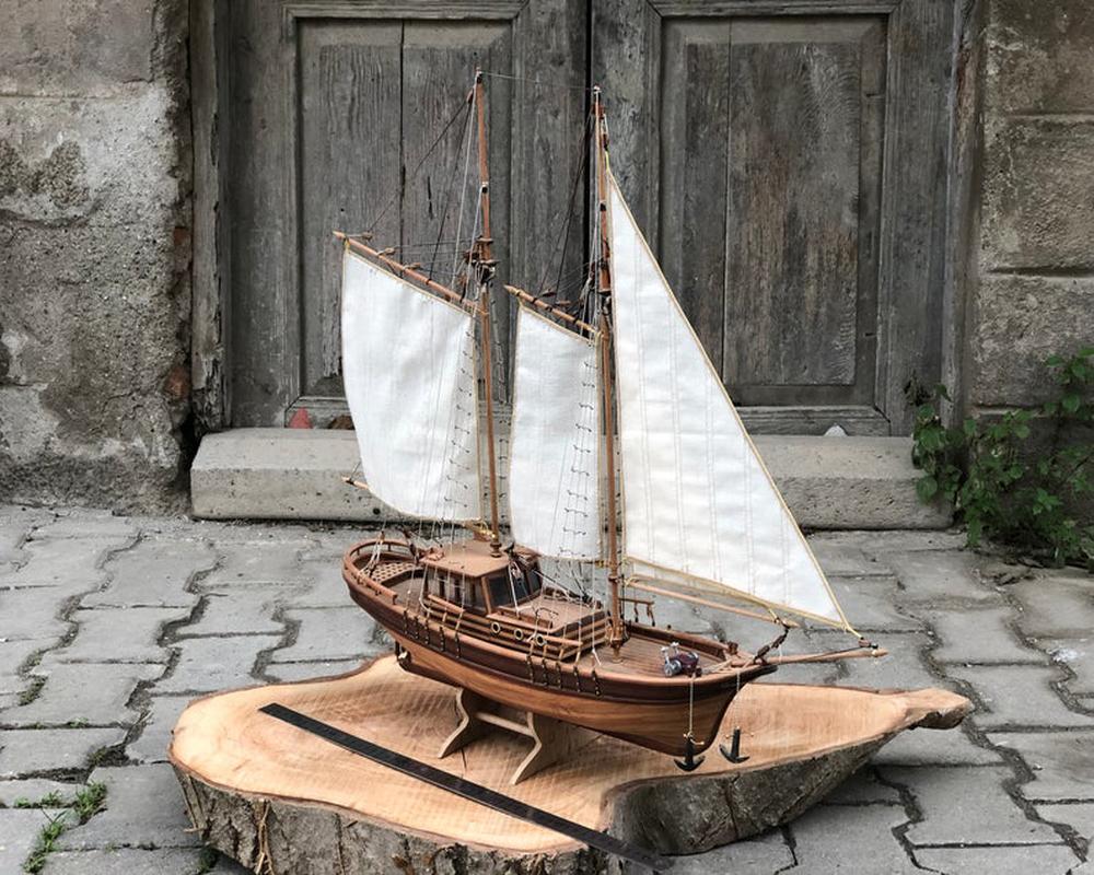This wooden sailboat model is mesmerizing with its handmade craftsmanship. The use of linden and mahogany trees adds a graceful touch. The result of long hours of work, this stunning piece measures 24.8 inches in length, 5.9 inches in width, and