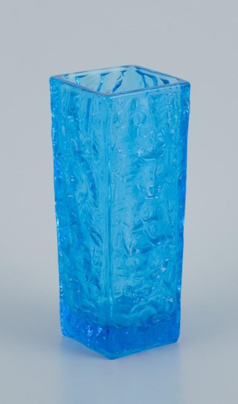 Gullaskruf, Sweden, square-shaped glass vase and candlestick in blue art glass.
Modernist design.
Late 20th century.
With label.
In perfect condition.
Vase: Height 19.7 cm, Diameter 7.2 cm.
Candlestick: Height 7.5 cm, Diameter 7.0 cm.