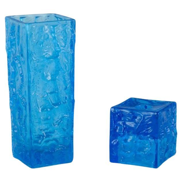 Gullaskruf, Sweden, square-shaped glass vase and candlestick in blue art glass. 