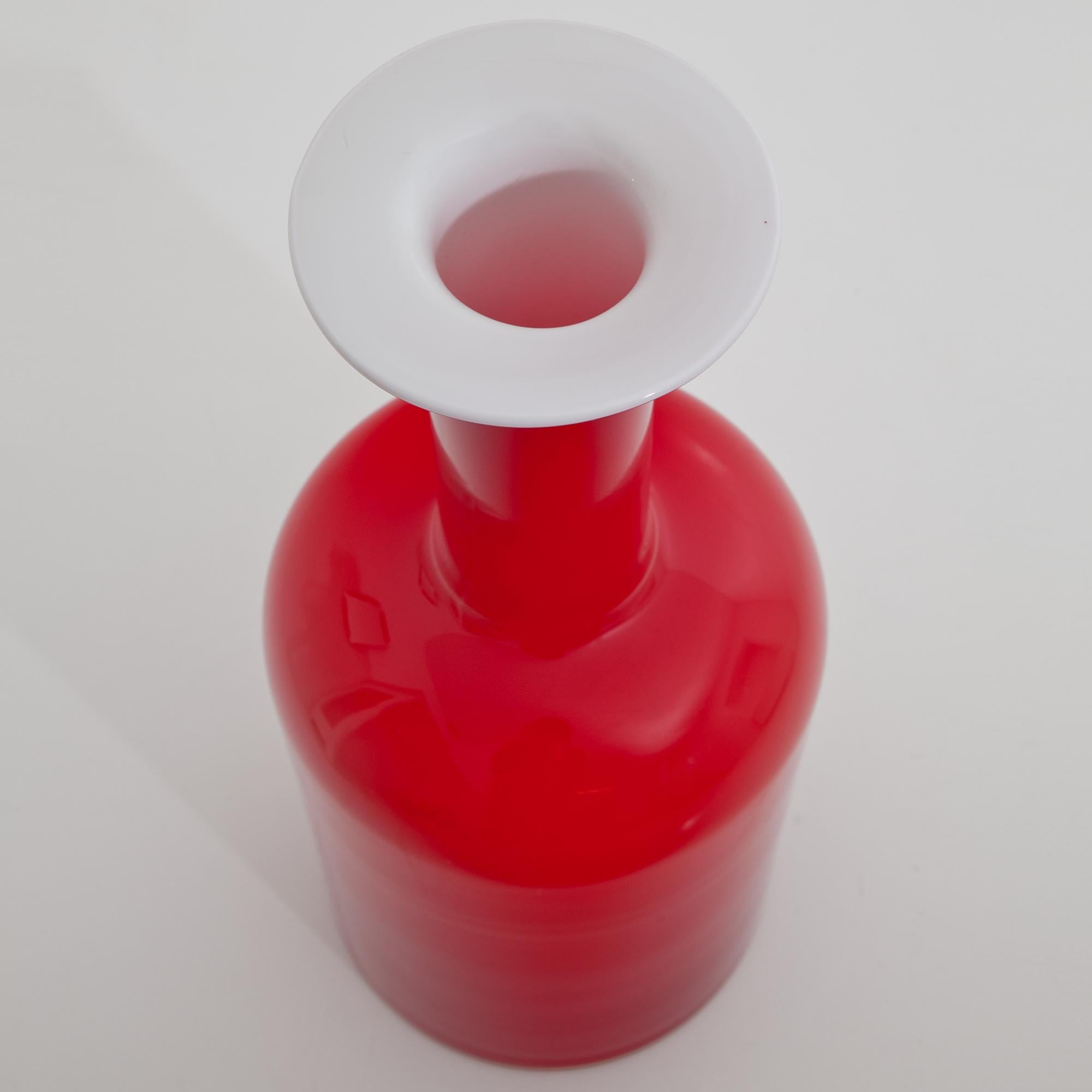 Large red vase designed by Otto Brauer for Kastrup Holmegaard, opaque white on the inside.