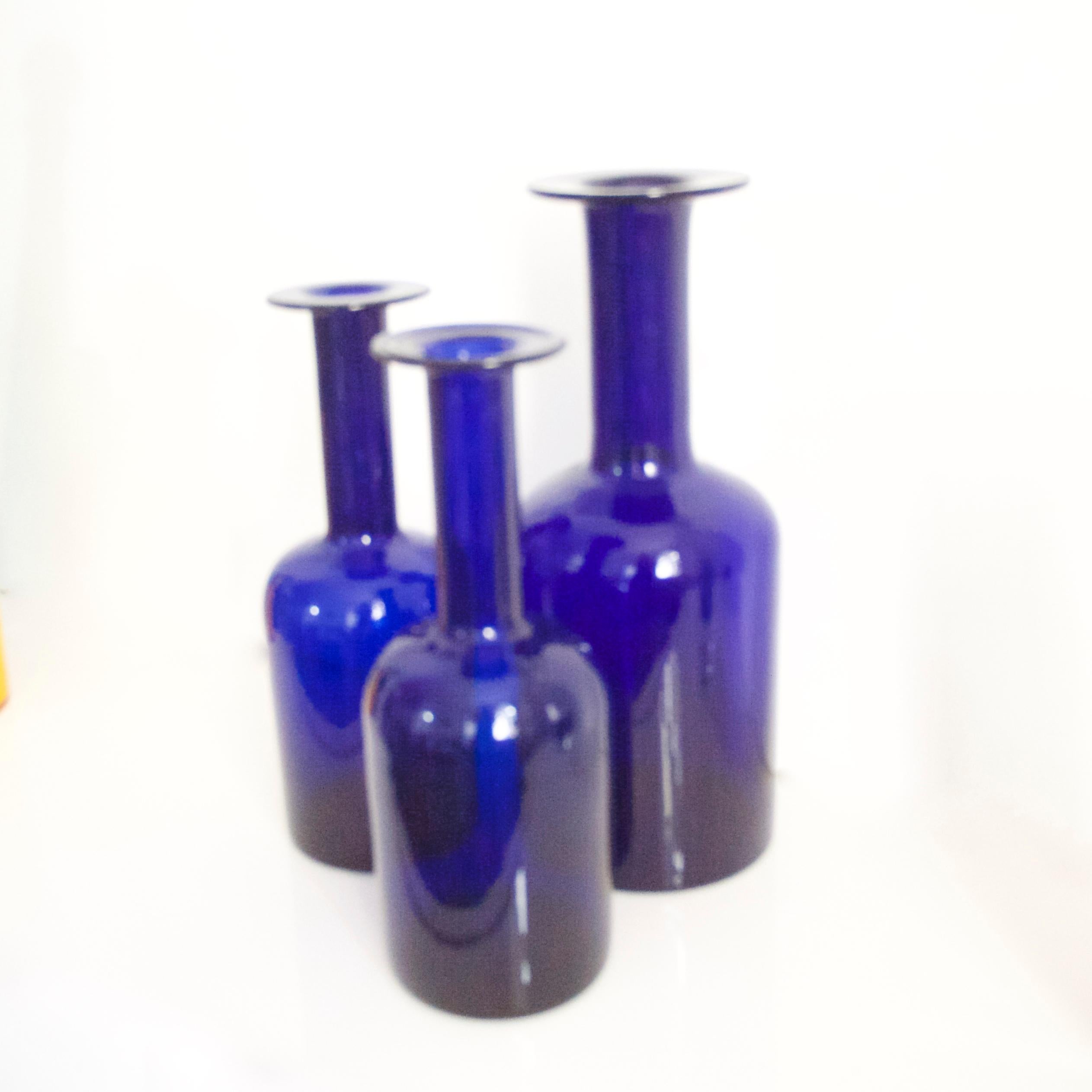 A three-piece pair of cobalt blue Gulvases by Otto Brauer based on a design by Per Lutken in 1958 for Holmegaard Kastrup

The larger vase is 30 cms in height the small 25 cms.