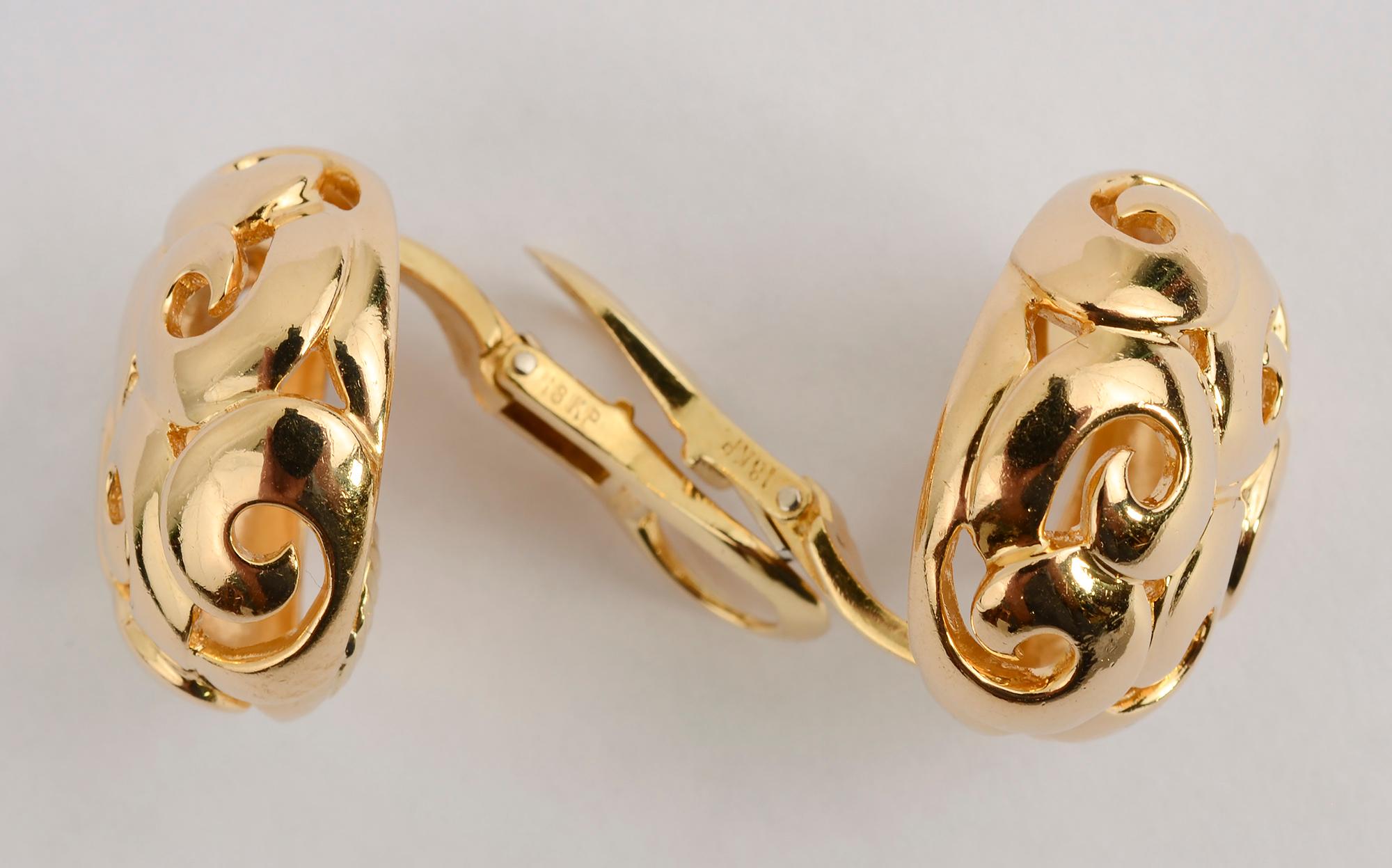 Gold dome earrings by Gumps with an interesting curlicue design giving open  space next to the metal. The earrings are 7/8 inch in diameter. Clip backs can be converted to posts.