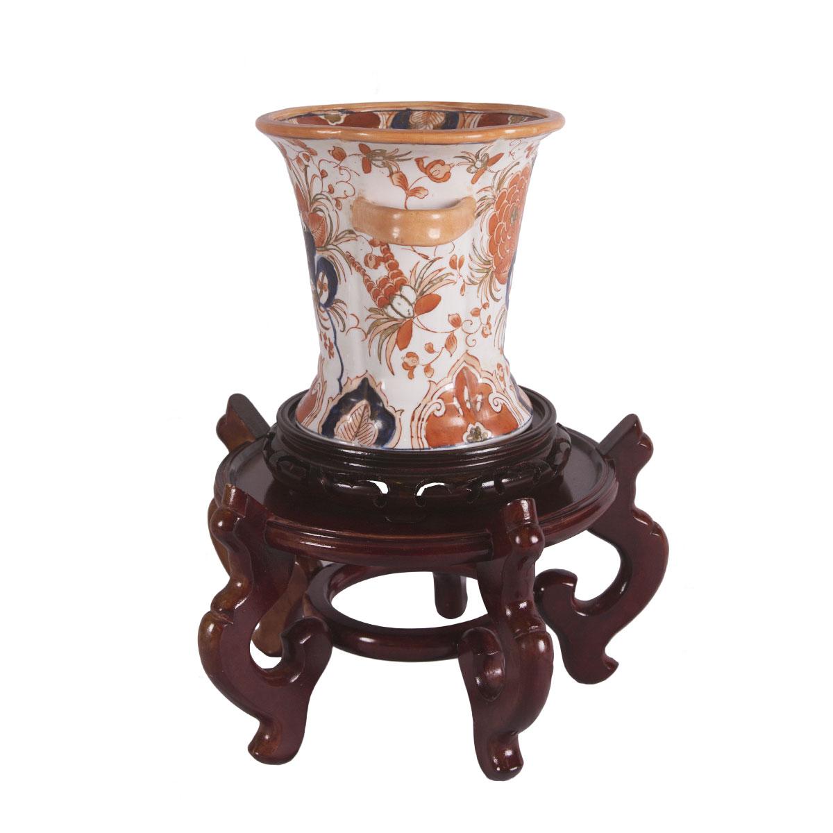 This Gump's hand painted vase with handles is made of porcelain and is inspired by 18th century Japanese potter. Includes both wooden stands as shown! Stands 15 inches tall on both stands and 8 inches tall on one stand. This vase is 10 inches in