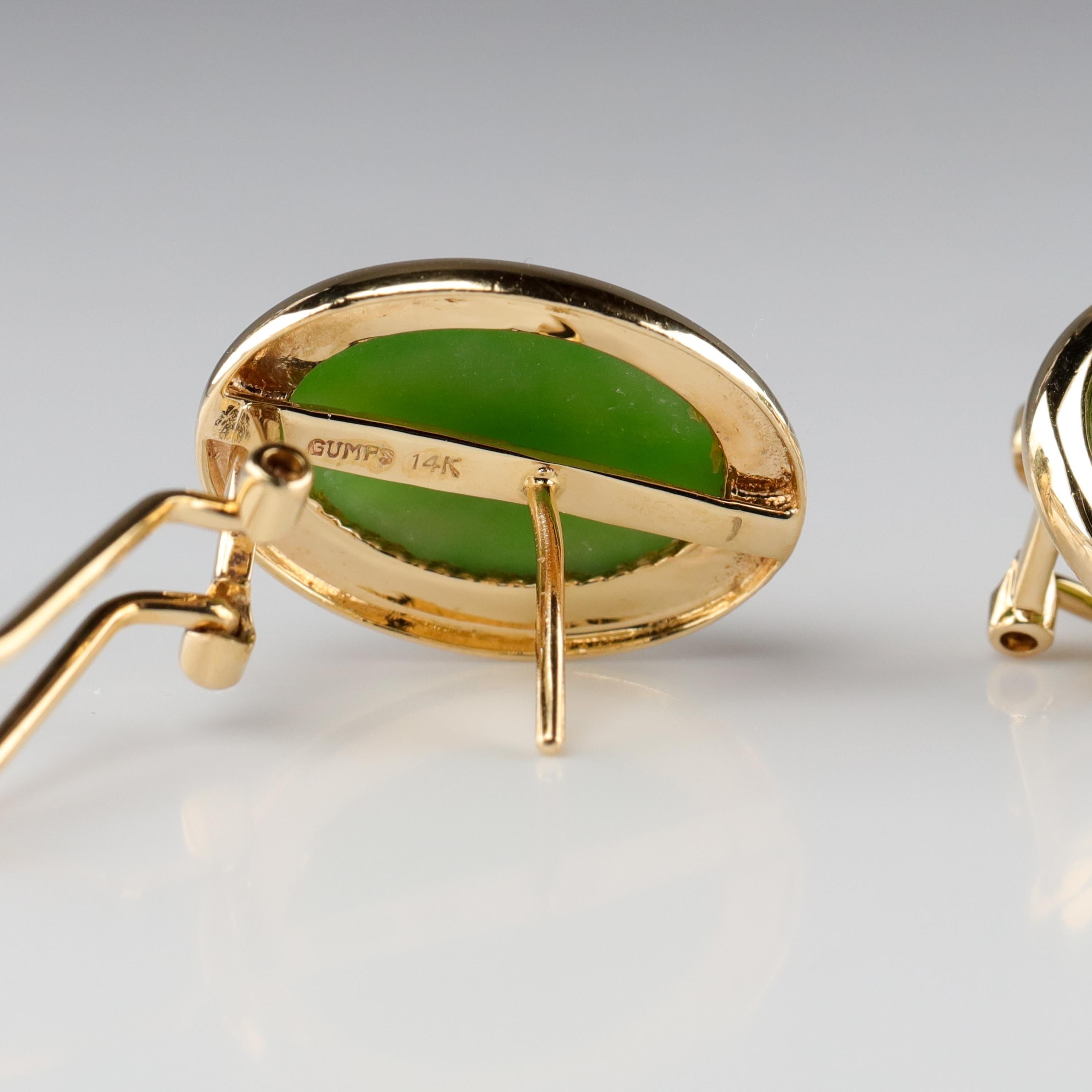These classic circa 1990s gemmy green nephrite jade earrings were created in the 1990s by the iconic San Francisco retailer, Gump's. The name Gump's has long been associated with fine jewelry, especially natural and untreated jade. Each