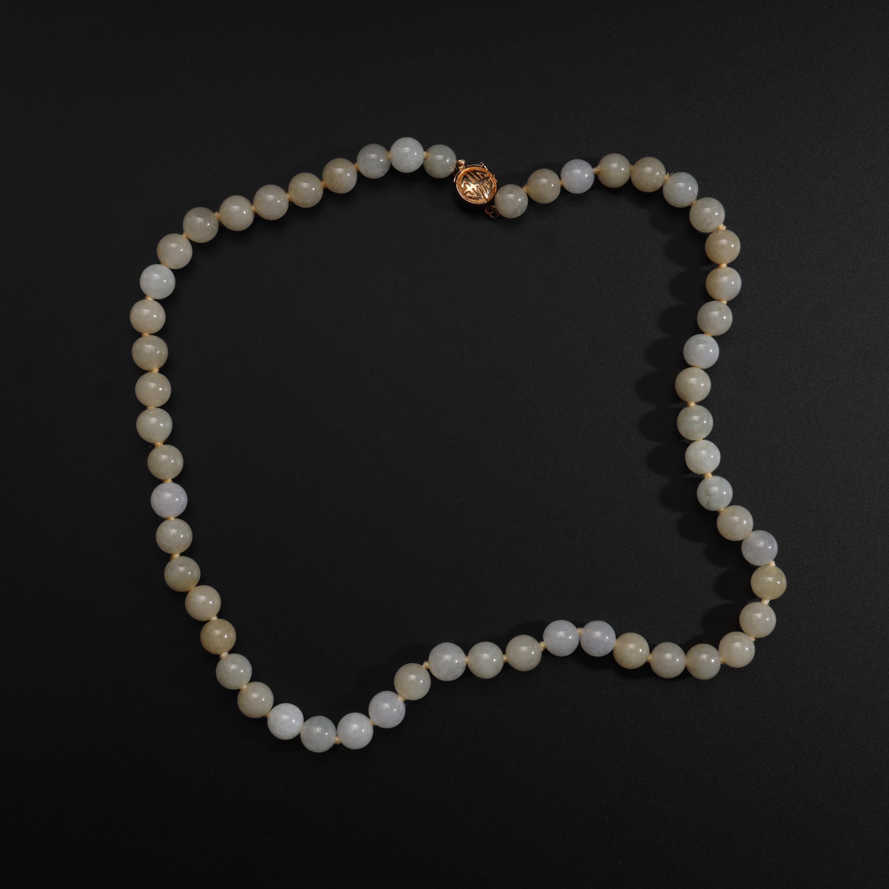 This gorgeous, ethereal Midcentury jadeite jade necklace was created by the iconic San Francisco retailer, Gump's, circa 1970. 

The luminous, translucent fog-toned jade beads measure approximately 8.83mm and are on their original silk string. The