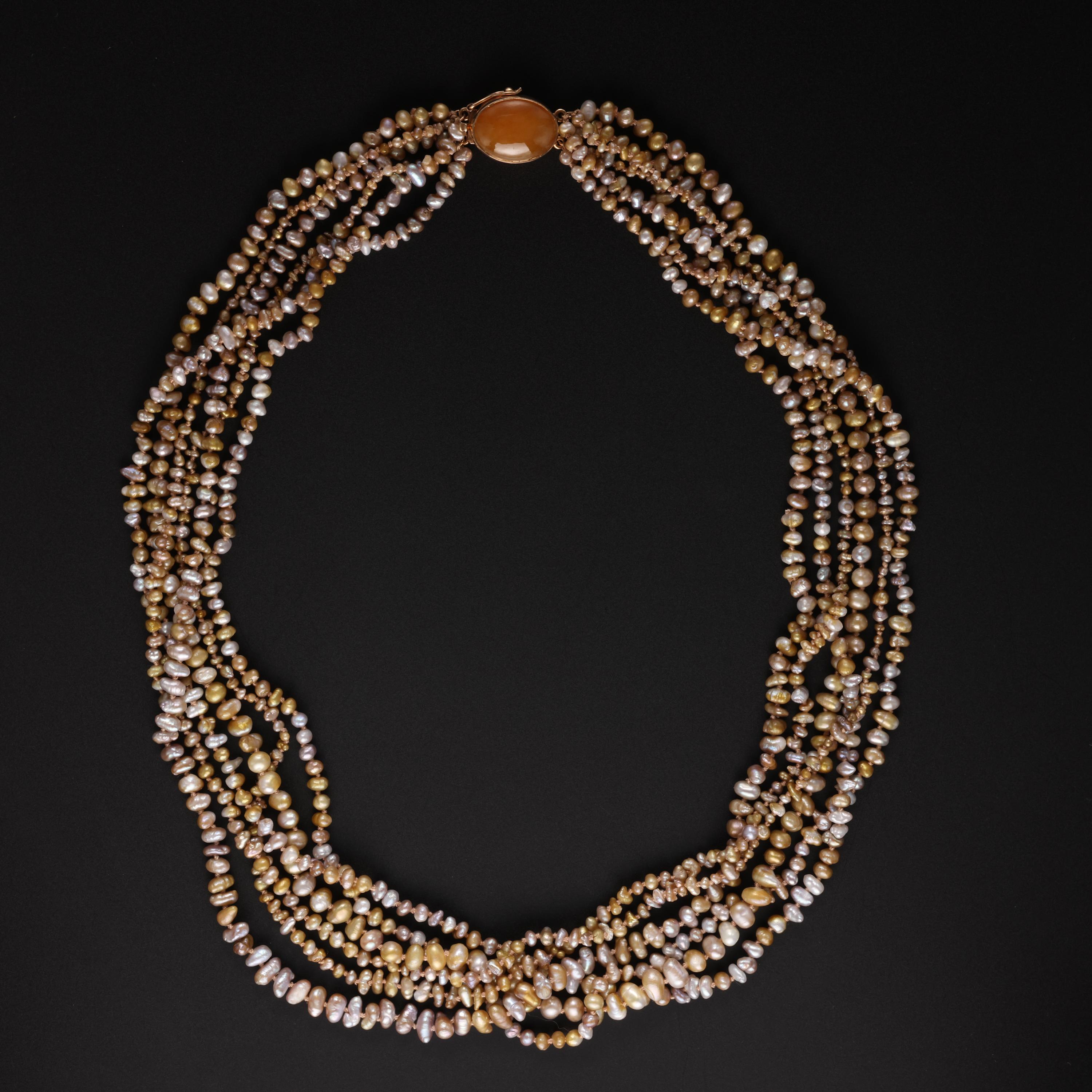 A spectacular and incredibly rare Gump's multi-strand torsade necklace composed of over 1,000 individual authentic Biwa pearls from Japan's famed Lake Biwa. A luminous, highly translucent cabochon of natural and untreated orange jadeite jade