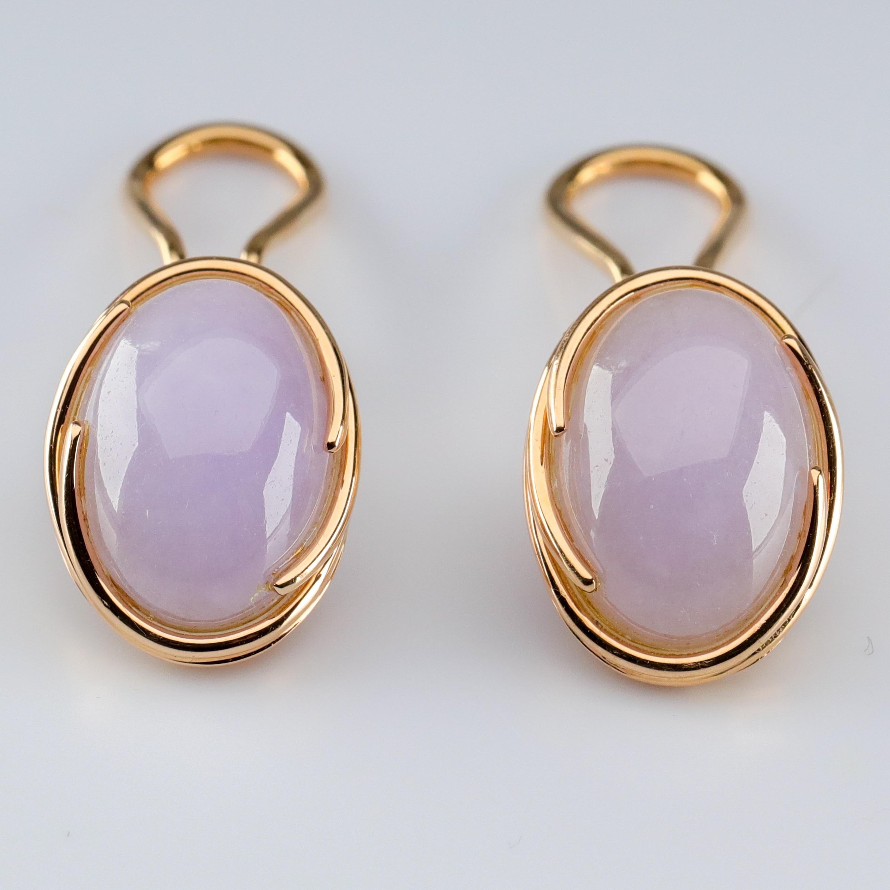 A pair of highly translucent double cabochons of luminous lavender jade are wrapped two swirls of gleaming 14K yellow gold in this late Mid-Century (circa 1970s) jadeite jade clip-on earrings from the legendary retailer, Gump's of San Francisco. For